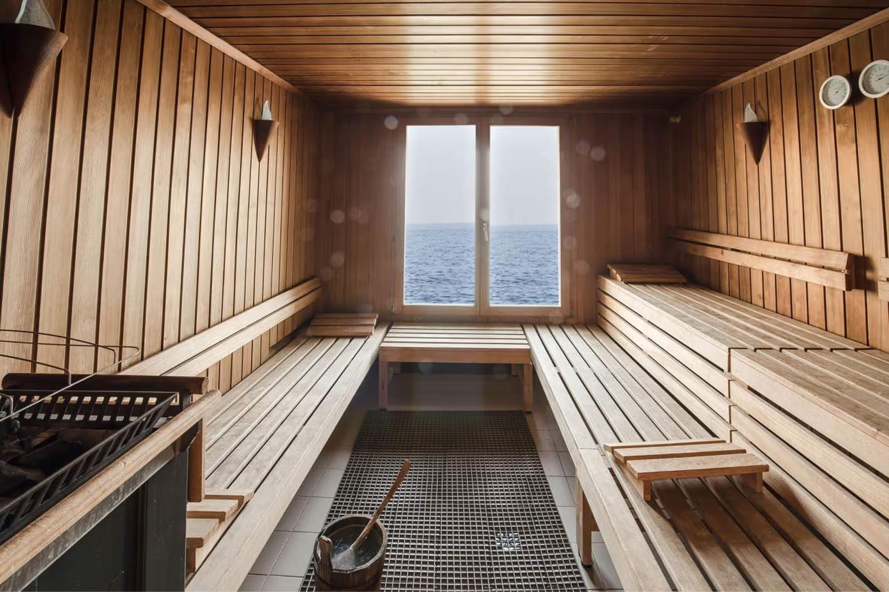 A sauna interior with wooden panels and views through glass