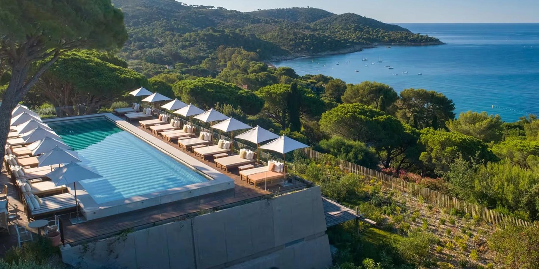 Pool with sun loungers overlooking the Mediterranean at dusk