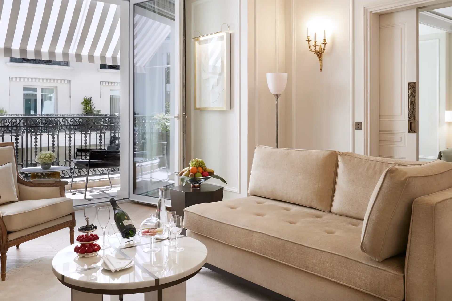 Suite sitting area with upholstered seating overlooking Monaco’s palace