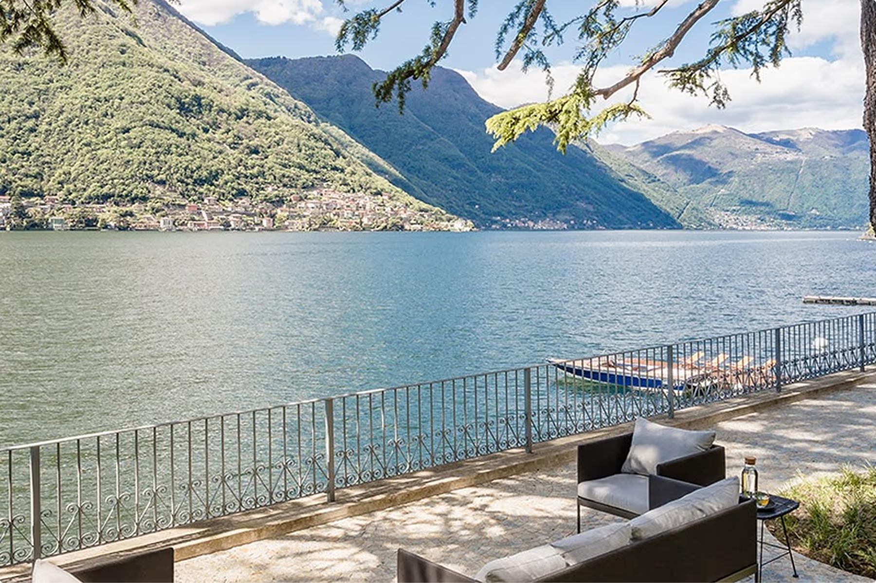 Villa Làrio: terrace with lounge seating overlooking lake and mountains at midday