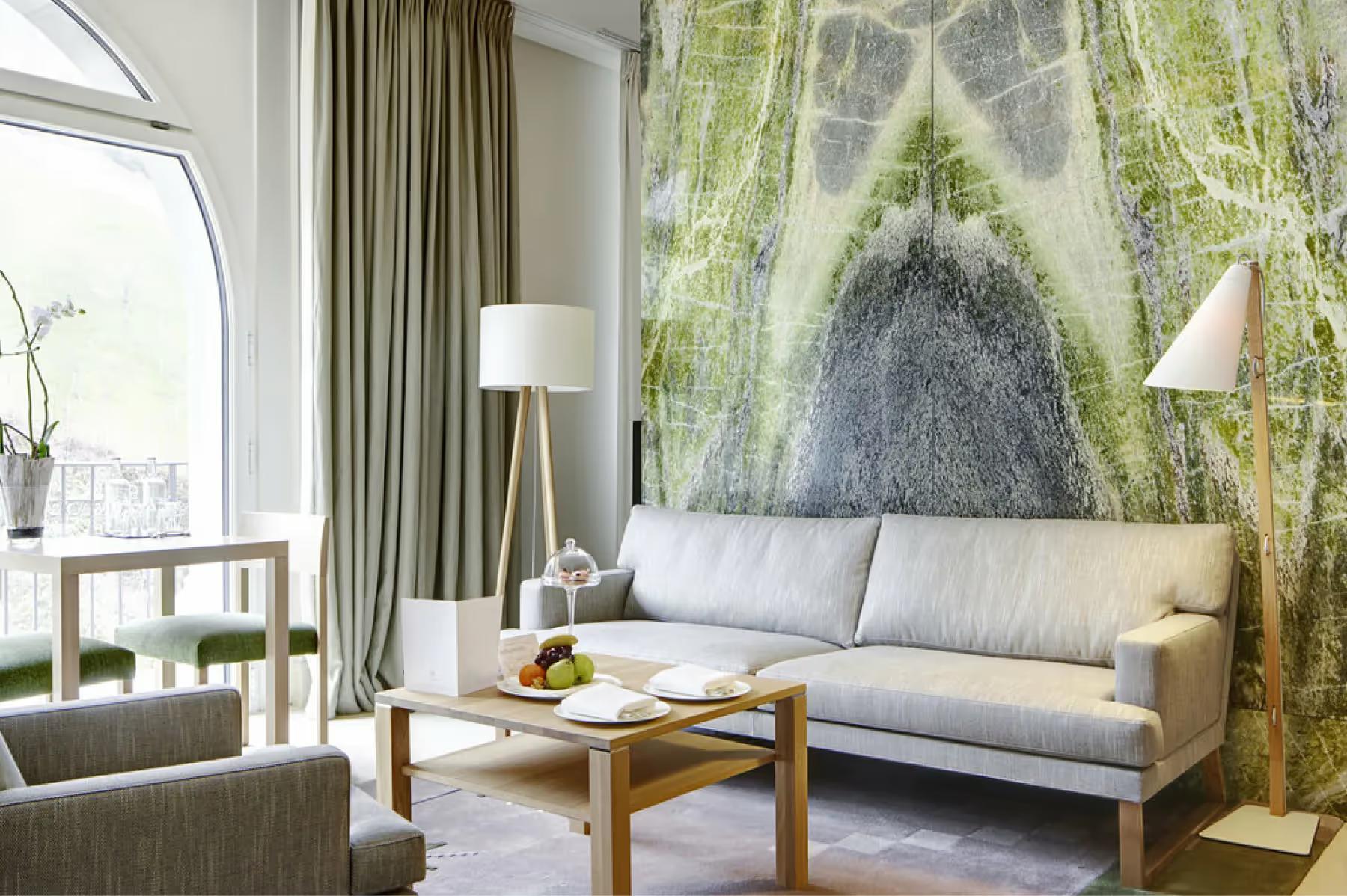 Lounge with large nature landscape wall mural and pale furniture