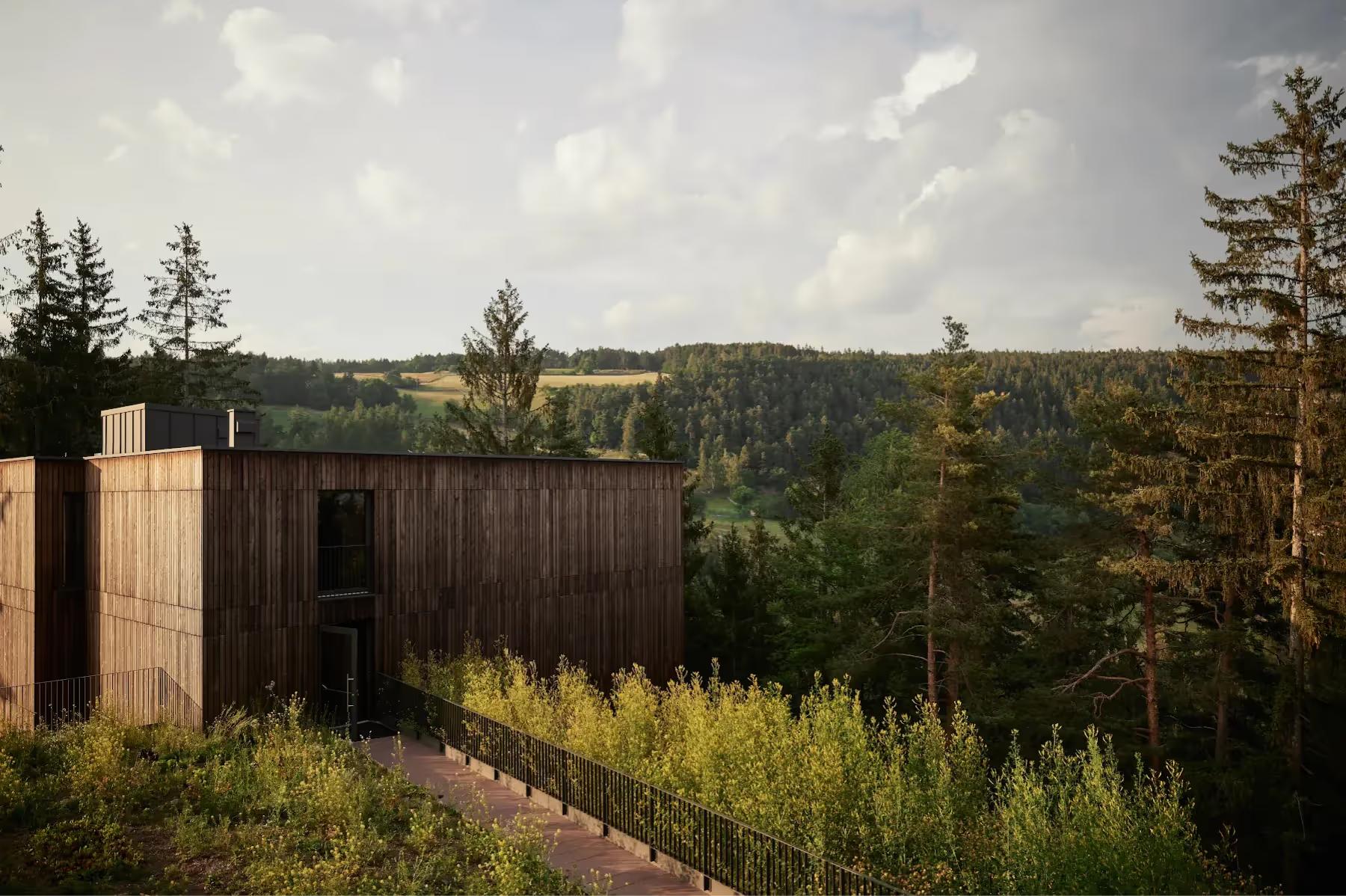 Wooden building set in rolling alpine meadows with surrounding spruce and larch trees