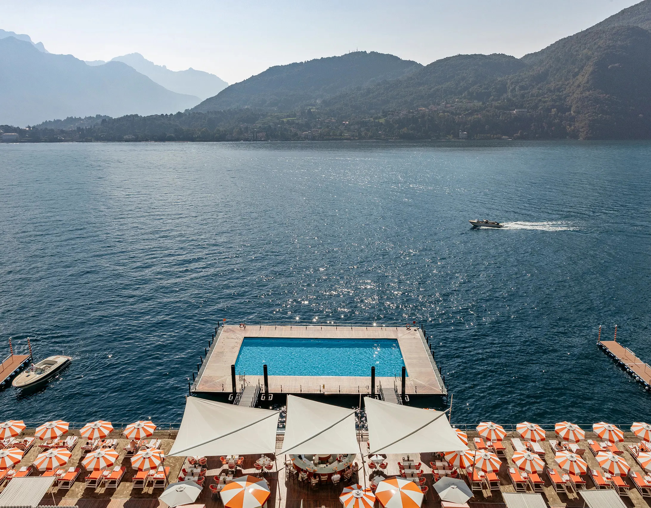 The renowned floating pool on Lake Como with mountain backdrop