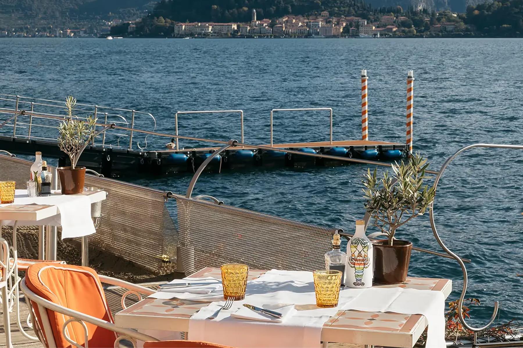 Outdoor table on lakeside platform with scenic water backdrop