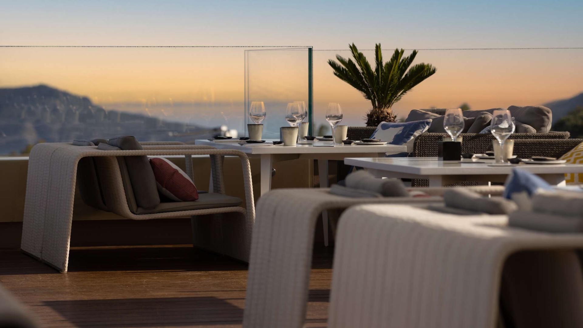 Restaurant interior with dining tables and mountain views