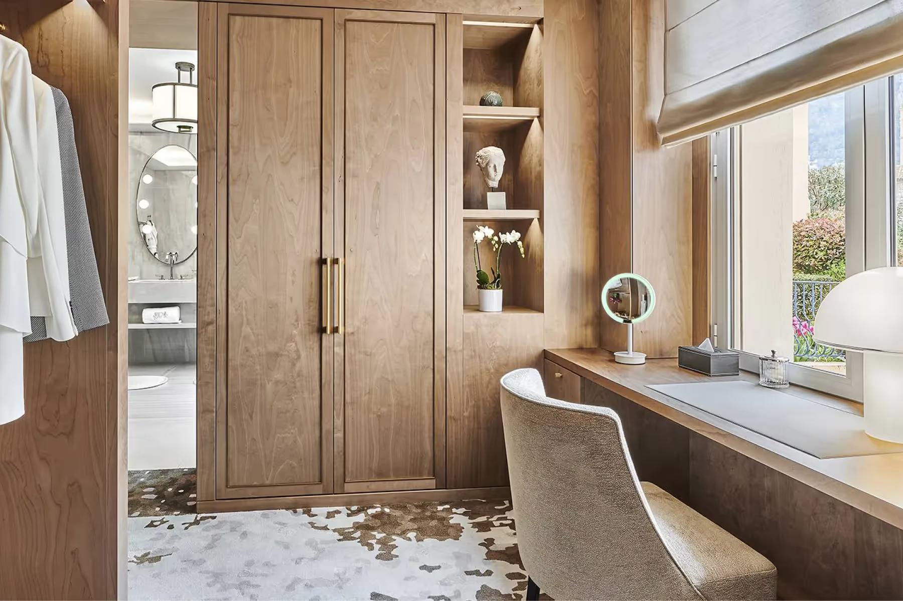 La Réserve de Beaulieu: dressing room with wood cabinetry and window seat overlooking the property