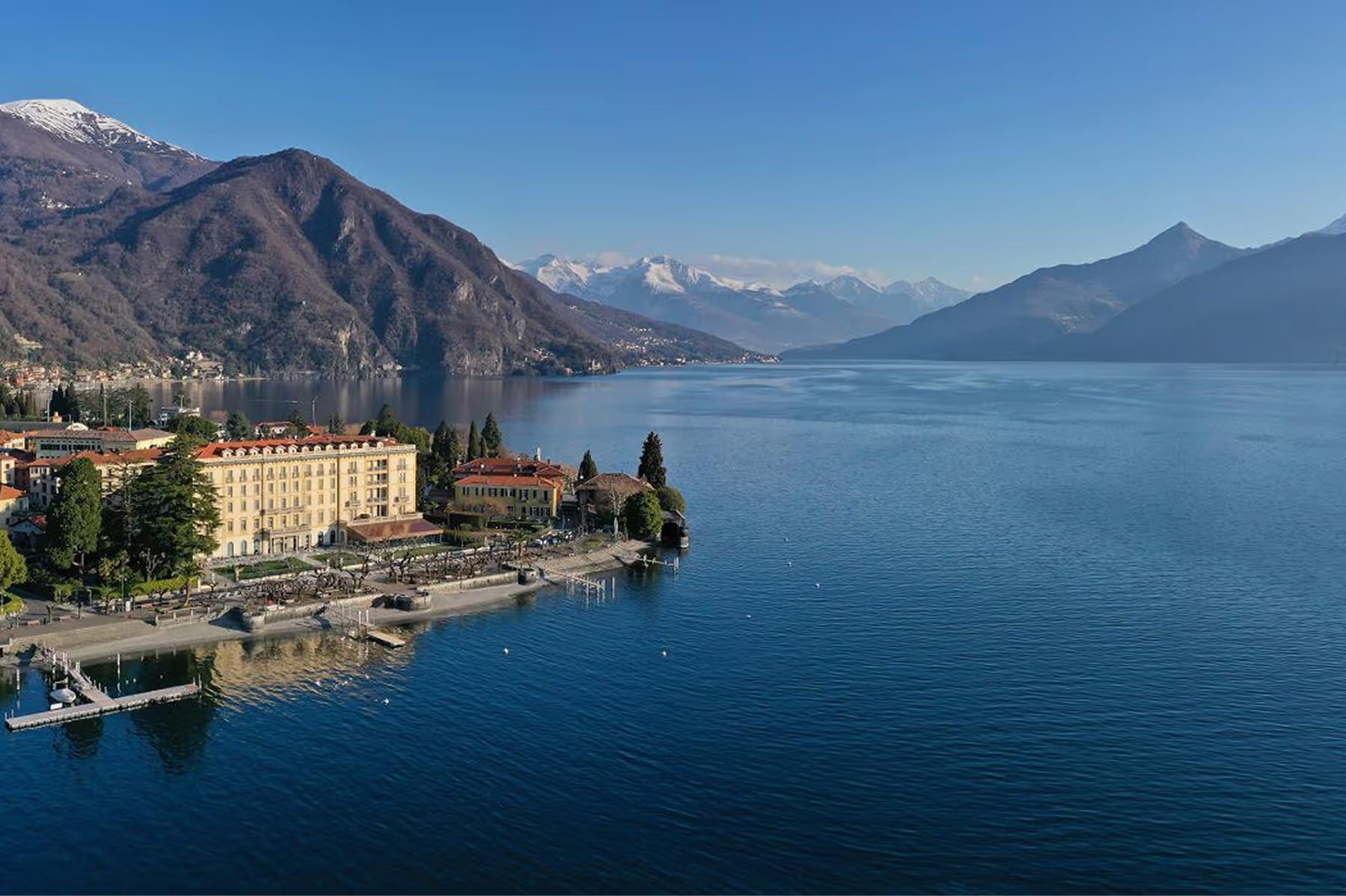 Aerial view of the hotel situated on the lakeshore with mountains