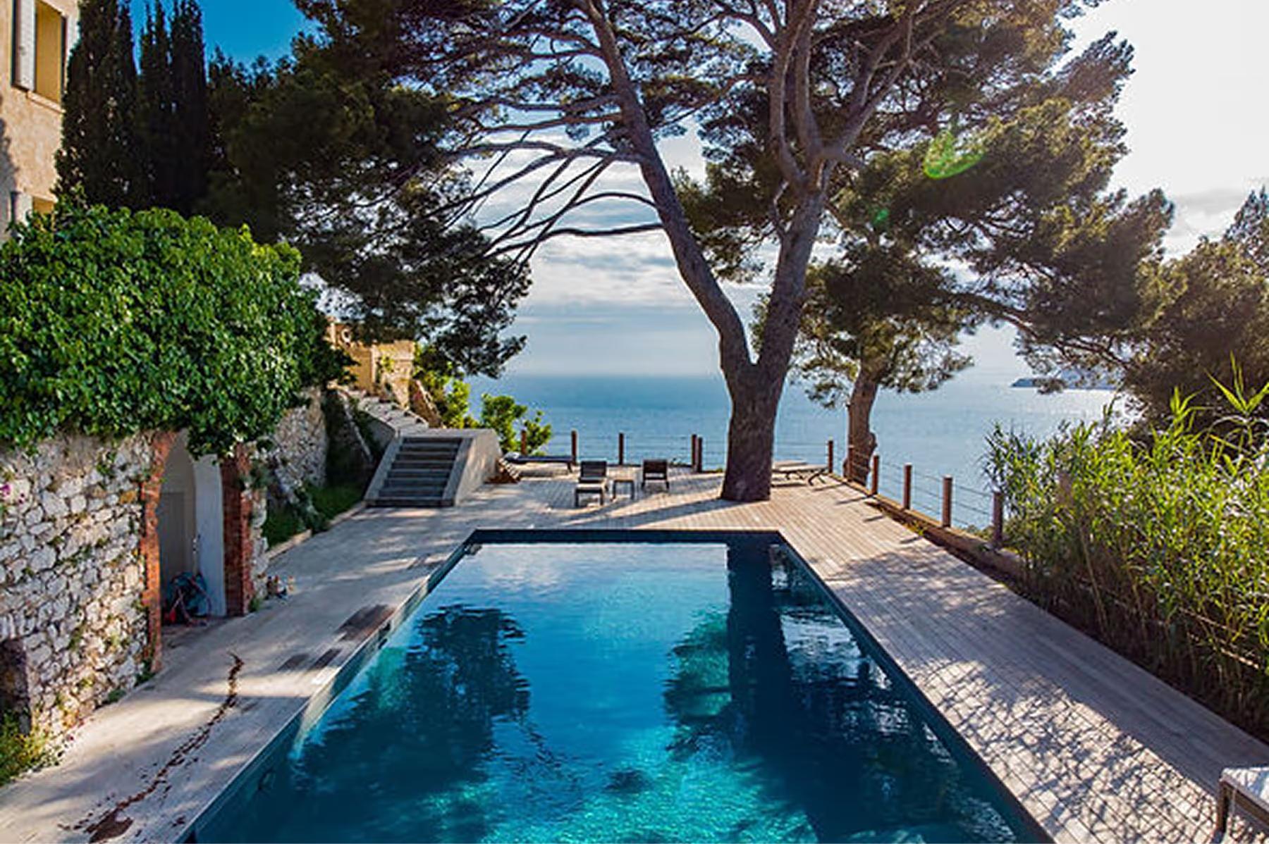 Le Domaine de Canaille: infinity pool with sea view, Mediterranean pines, and coastal landscape at golden hour