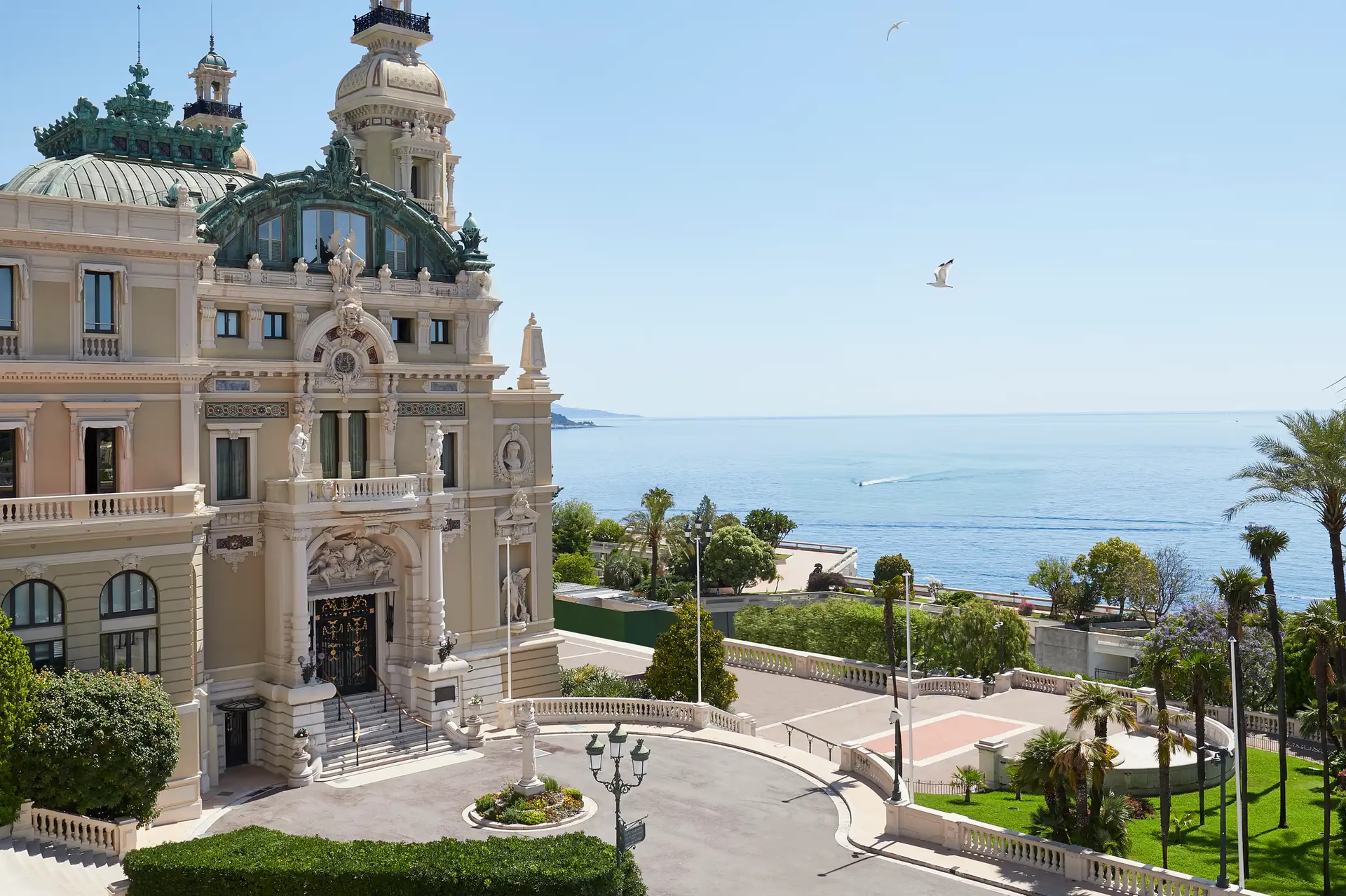 Hôtel de Paris Monte-Carlo: beige palazzo facade with towers overlooking the Mediterranean and palm trees