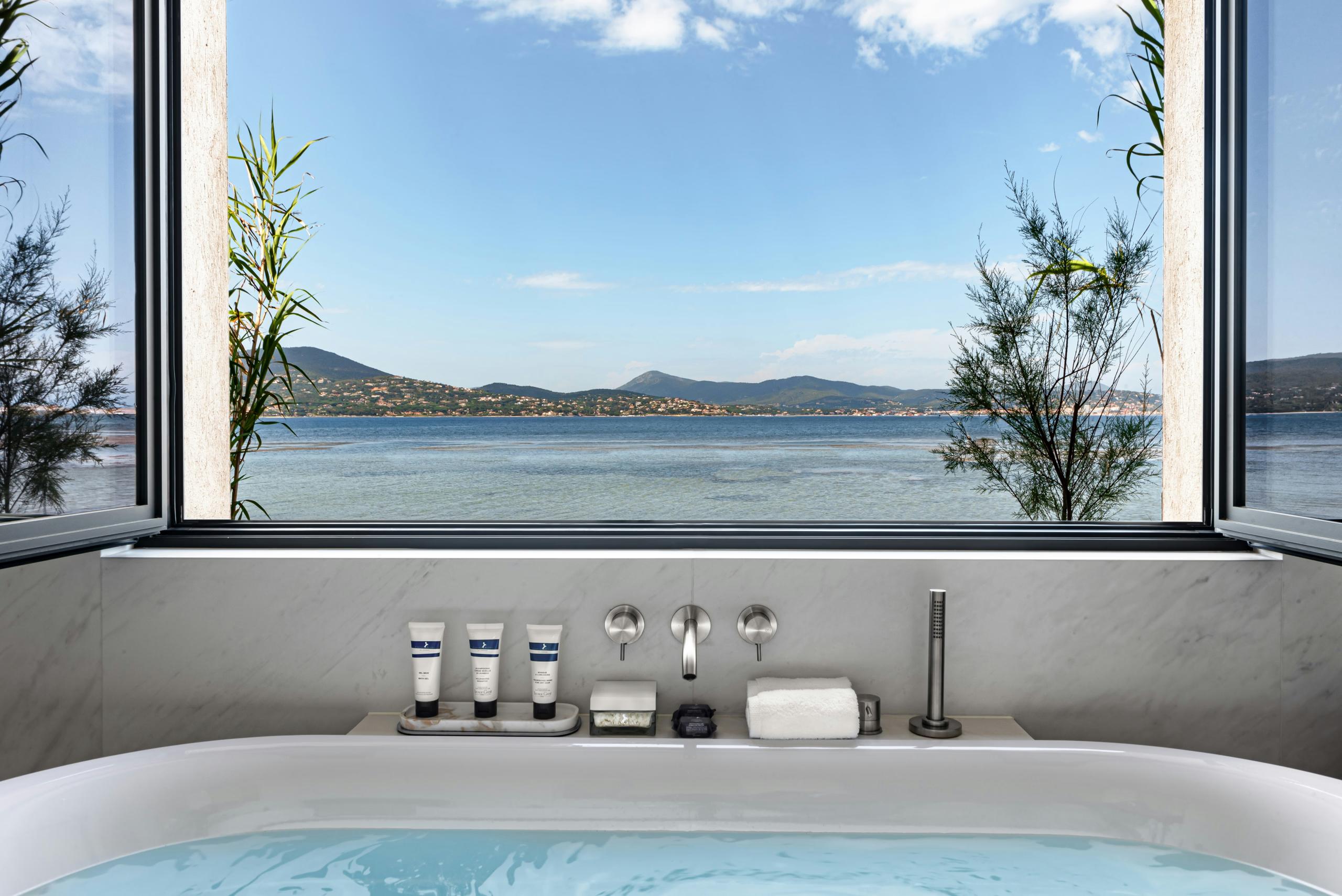 Cheval Blanc St-Tropez: soaking tub with landscape window framing sea and distant hills
