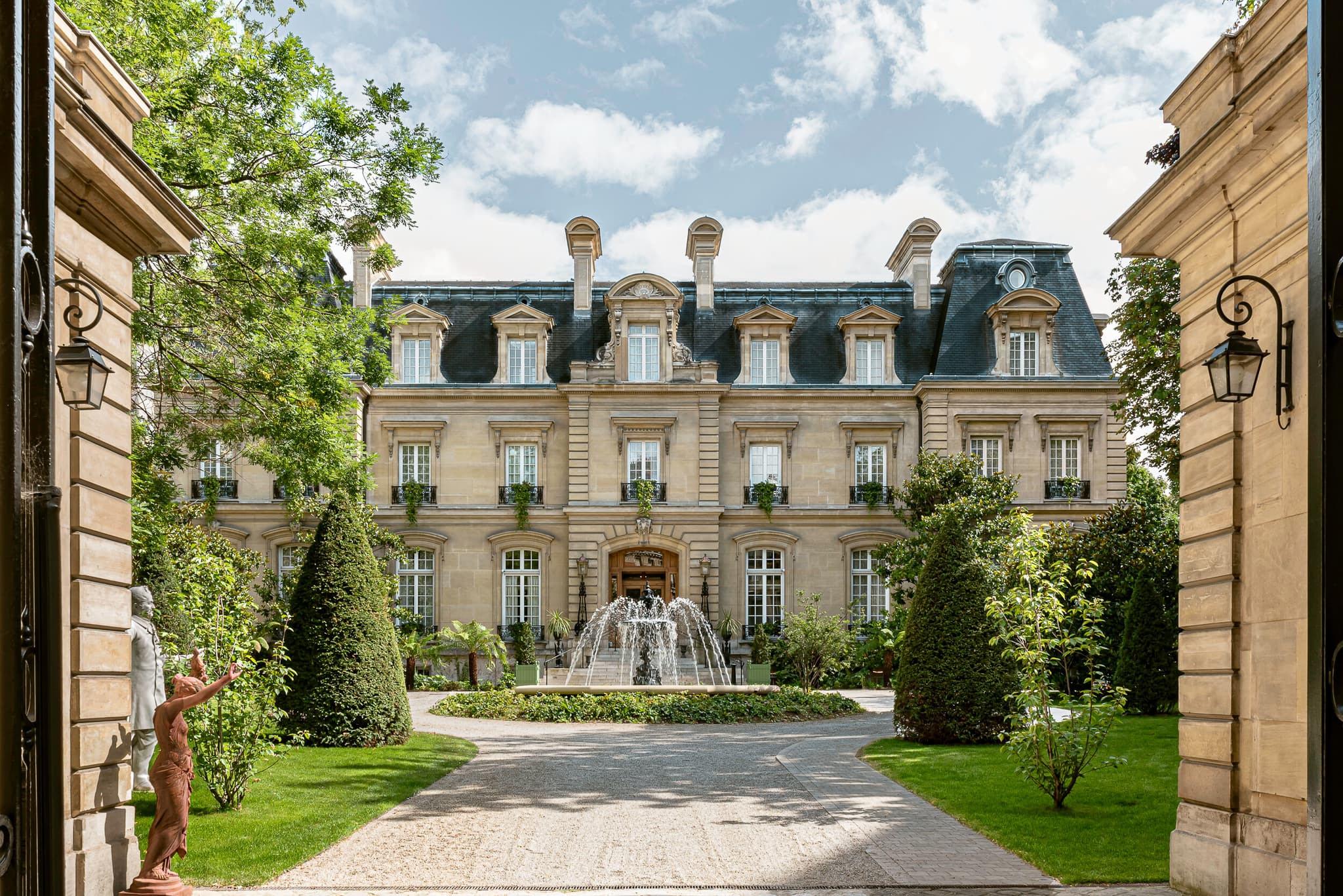 Saint James: neoclassical château approached through landscaped courtyard, gravel path leading to ornate entrance