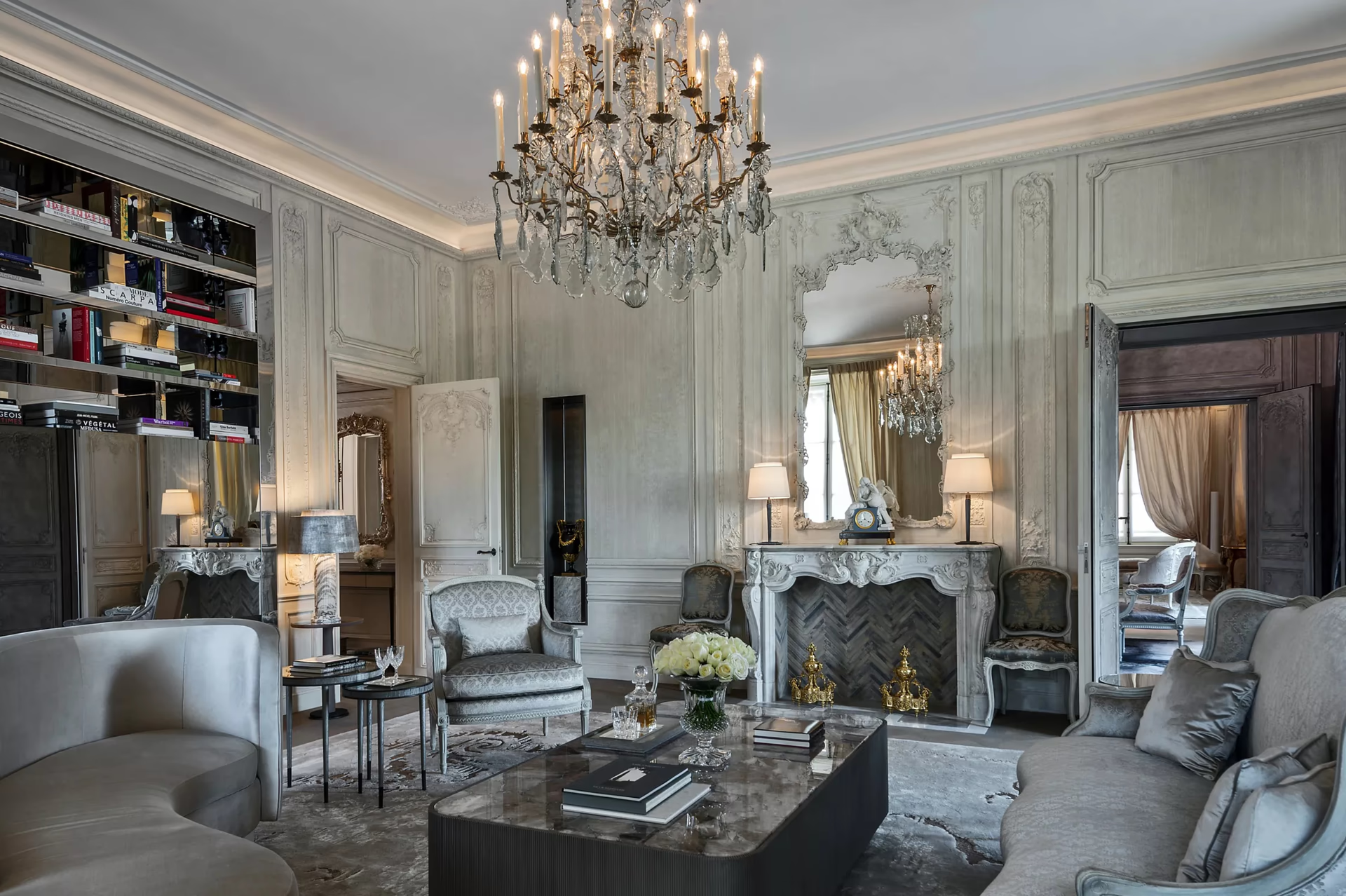 Hôtel de Crillon: formal suite with white marble fireplace, arched doorways, and pale color scheme