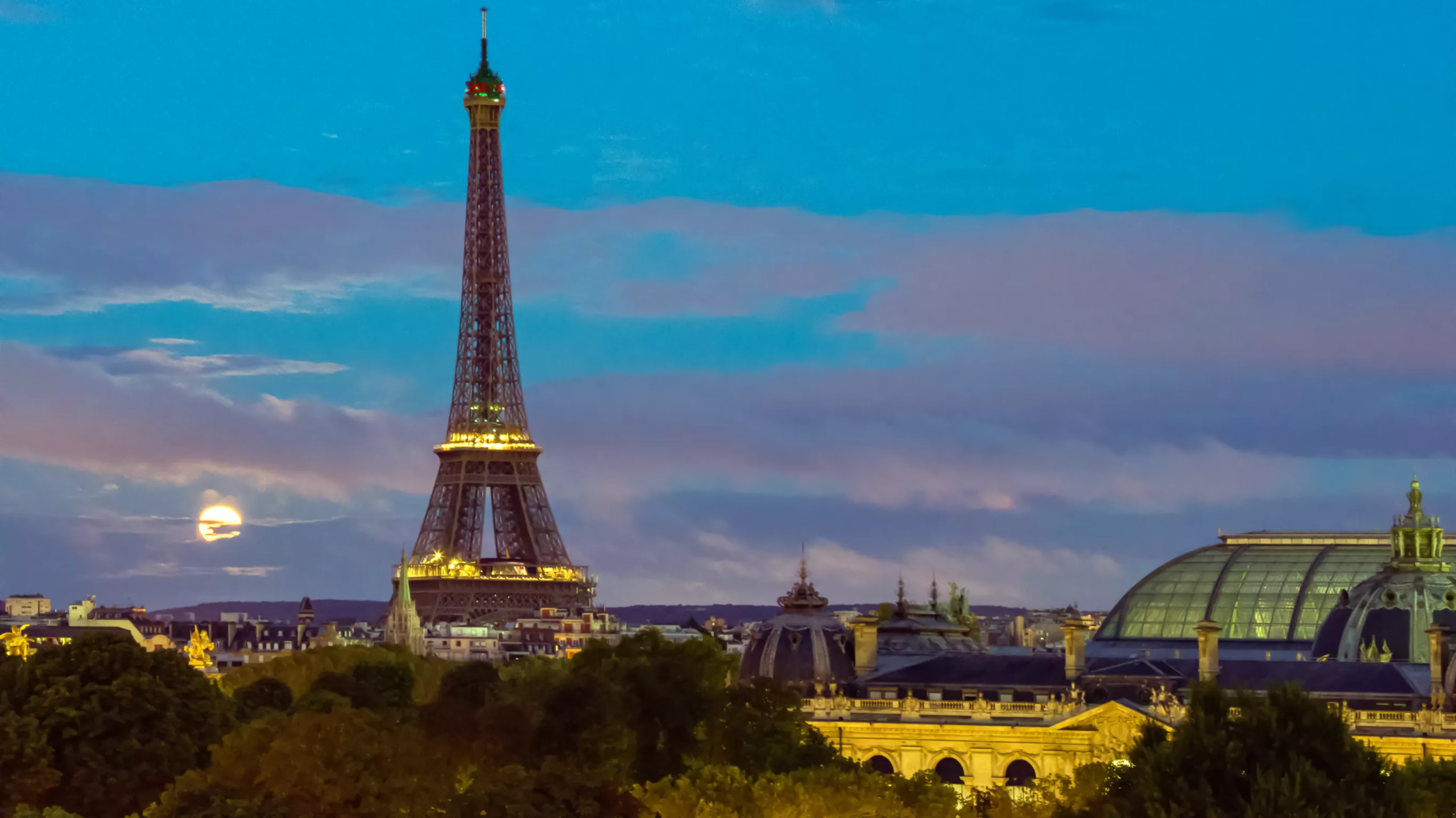 Hôtel de Crillon: illuminated Eiffel Tower visible through bedroom window at night