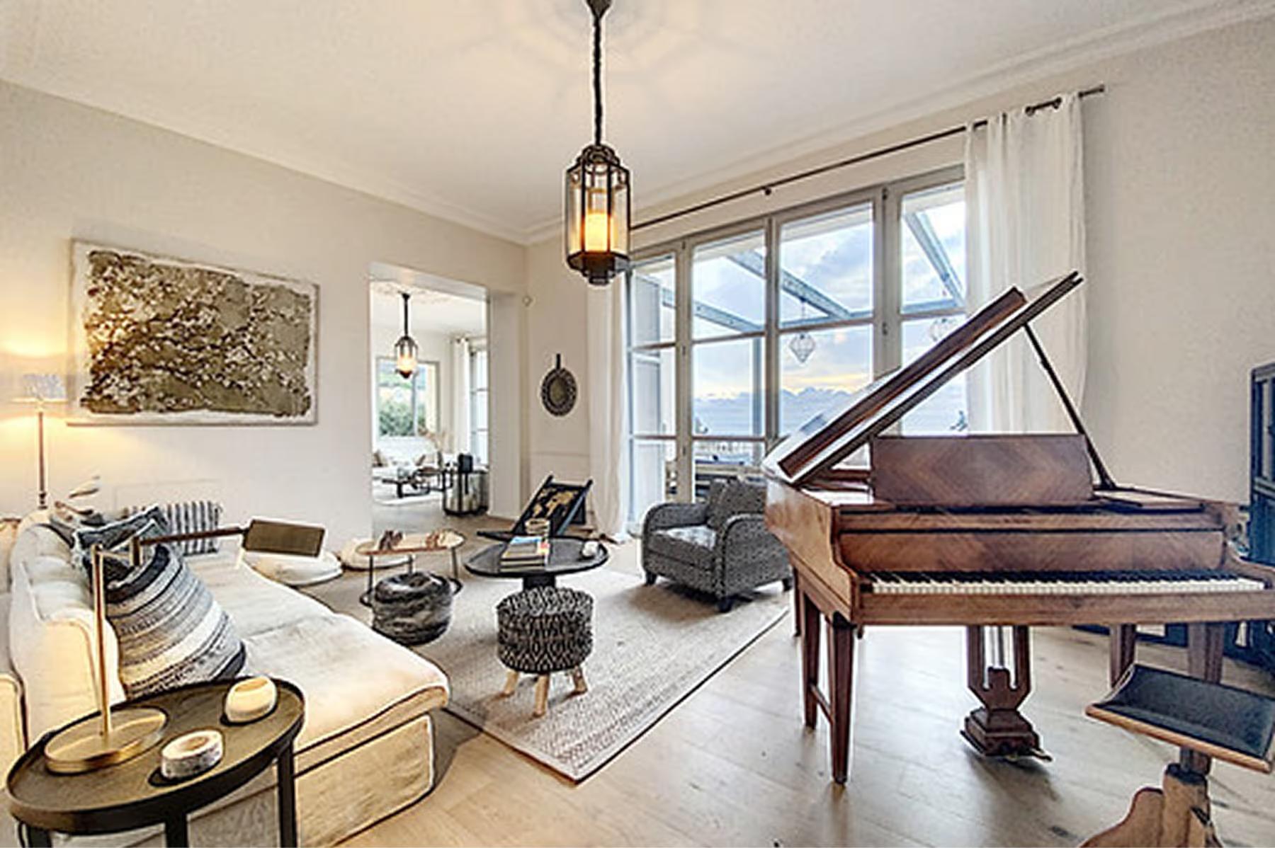 Le Domaine de Canaille: living room with black piano, beige upholstered seating, and glass doors to sea-facing terrace