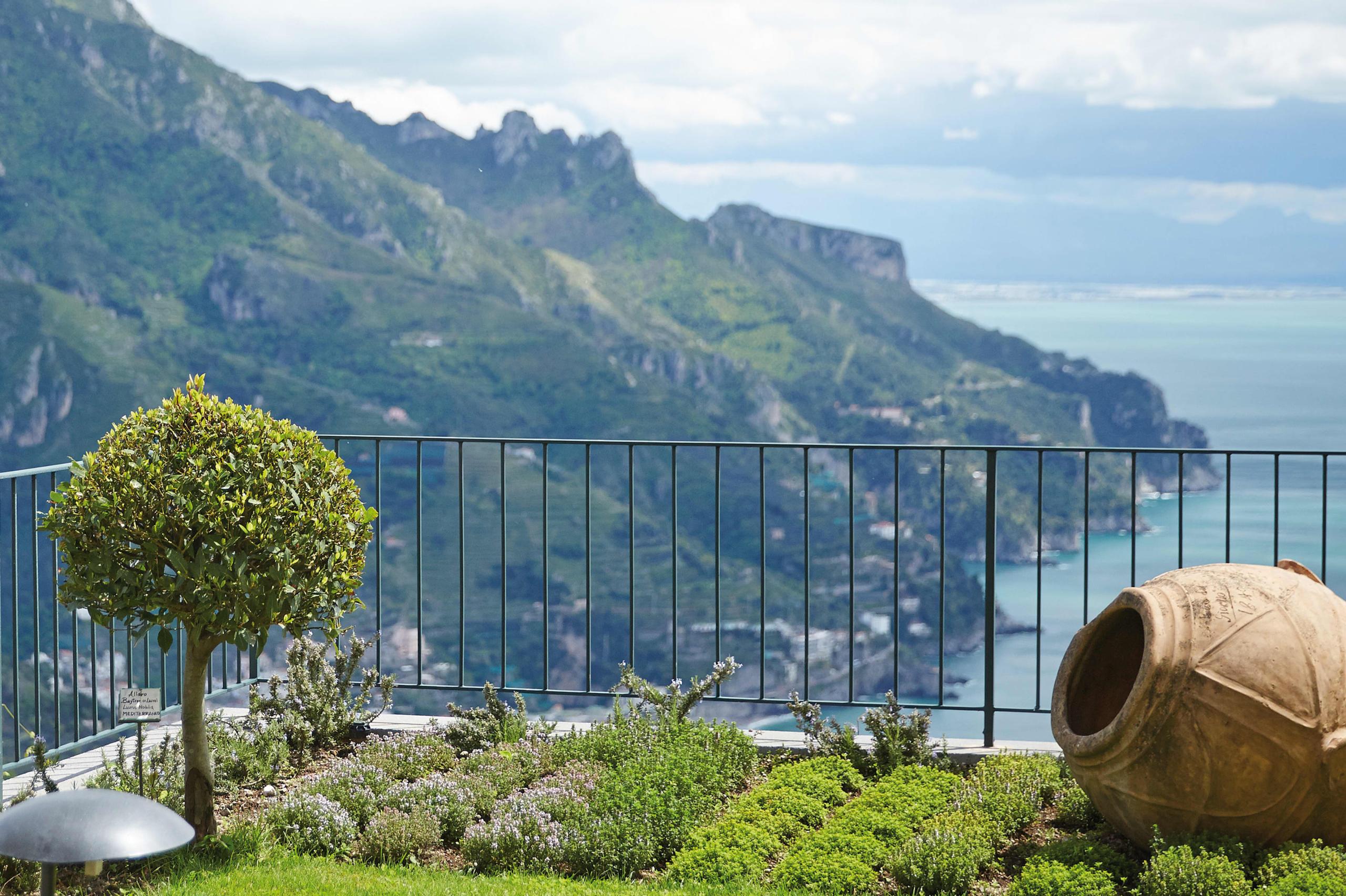 Caruso: terraced garden with sculptured planter overlooking forested hillsides and Mediterranean sea