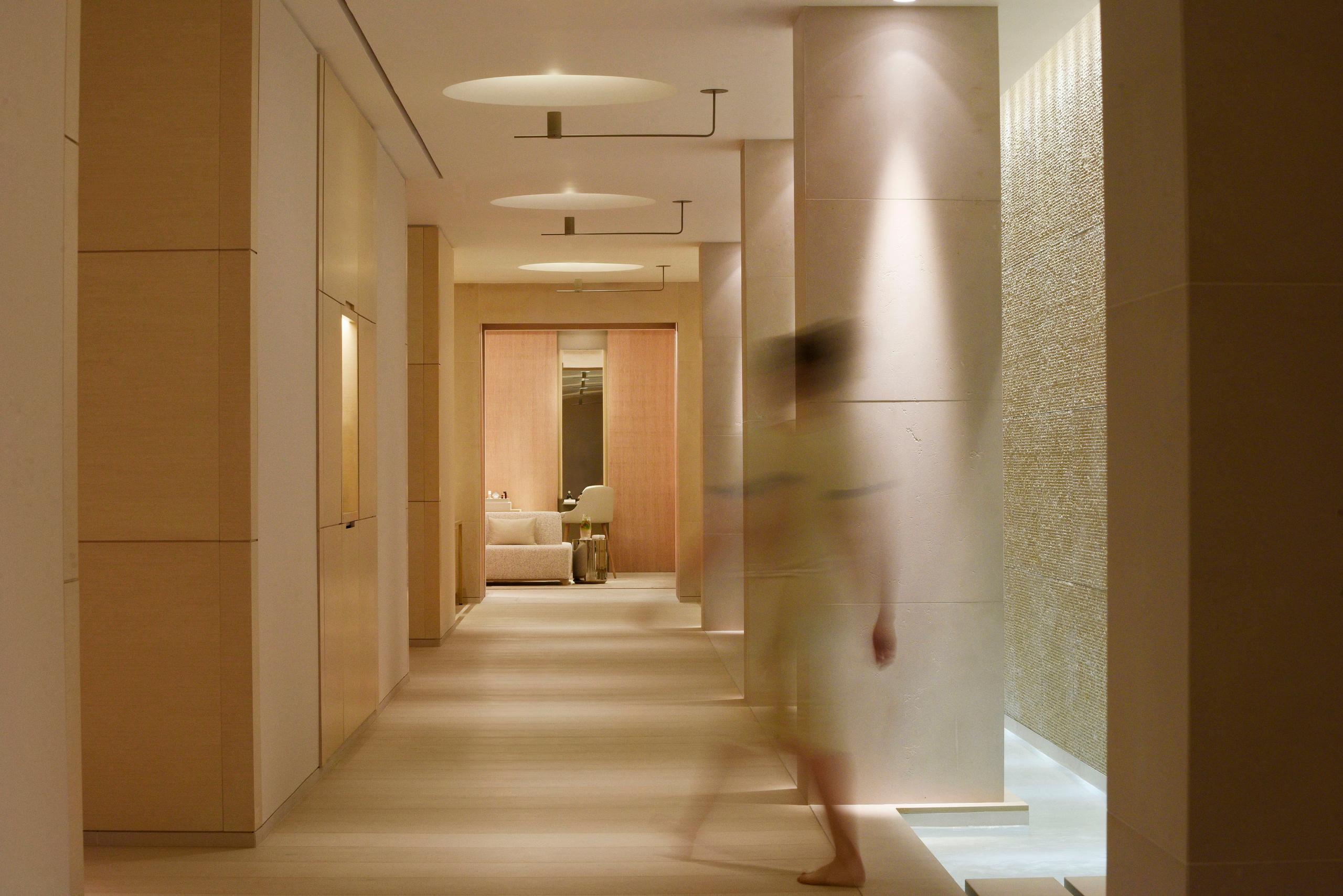 Spa corridor with taupe walls and subtle lighting
