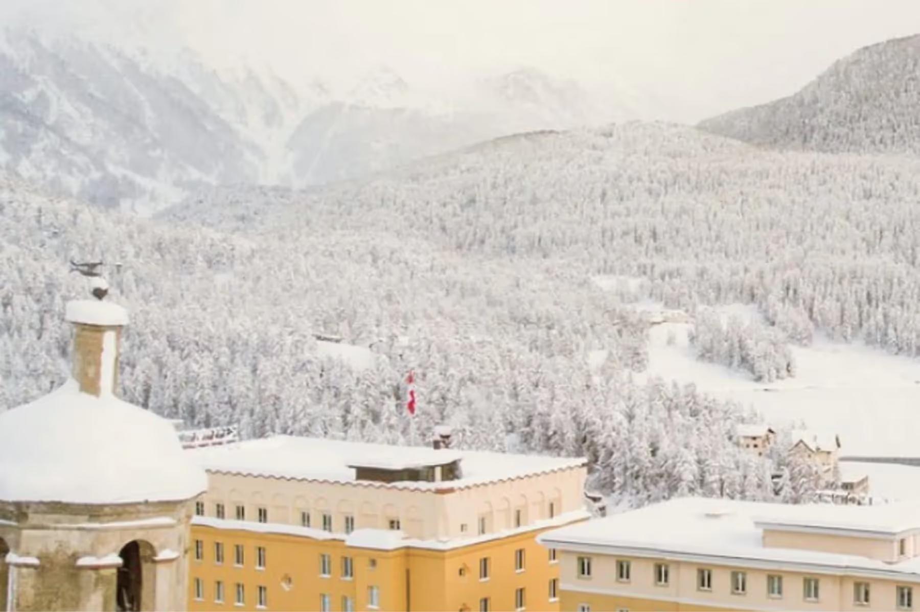 The hotel building with snow-covered peaks in the background at sunrise