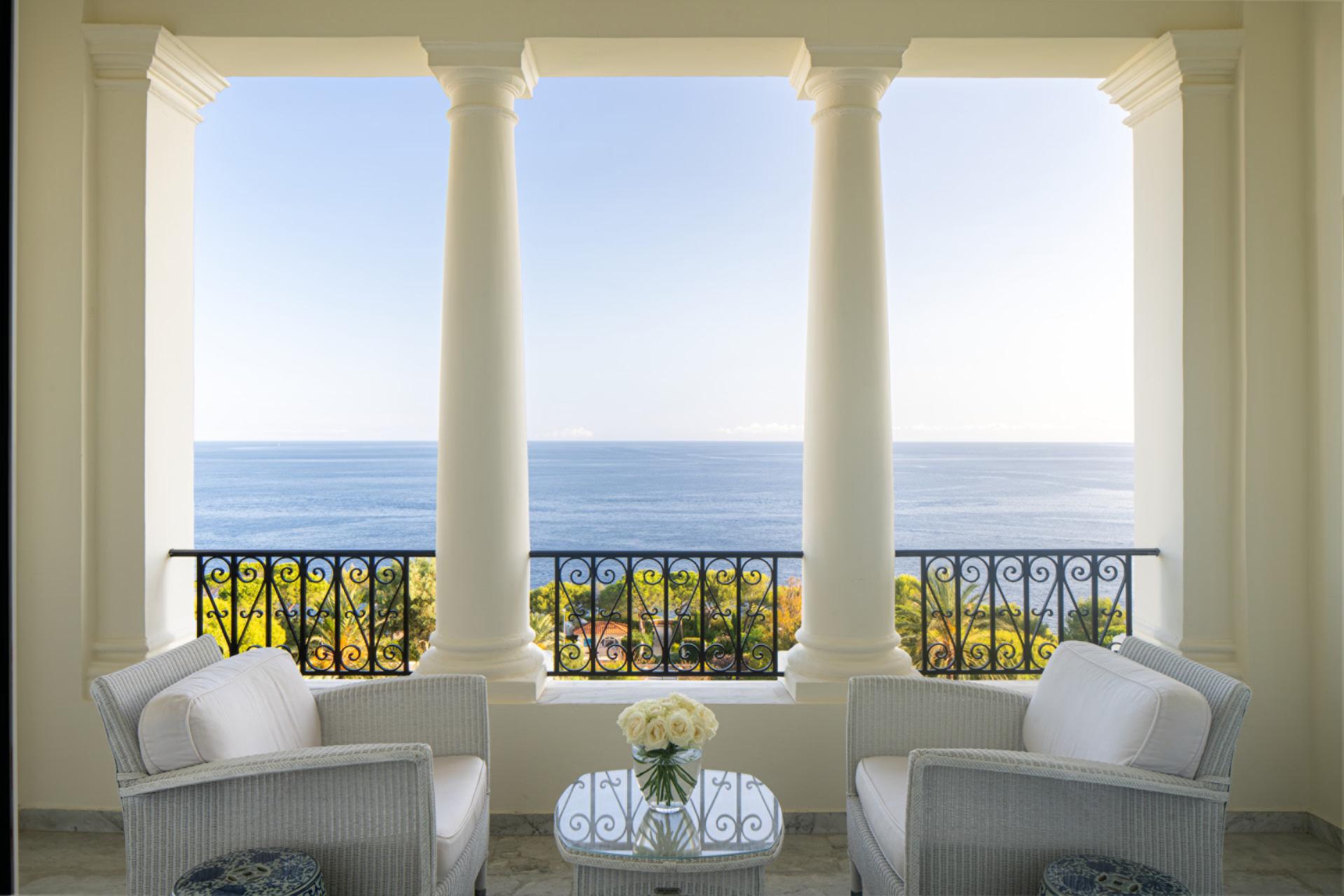 Grand-Hôtel du Cap-Ferrat: three arched windows with sea views and armchairs overlooking the Mediterranean