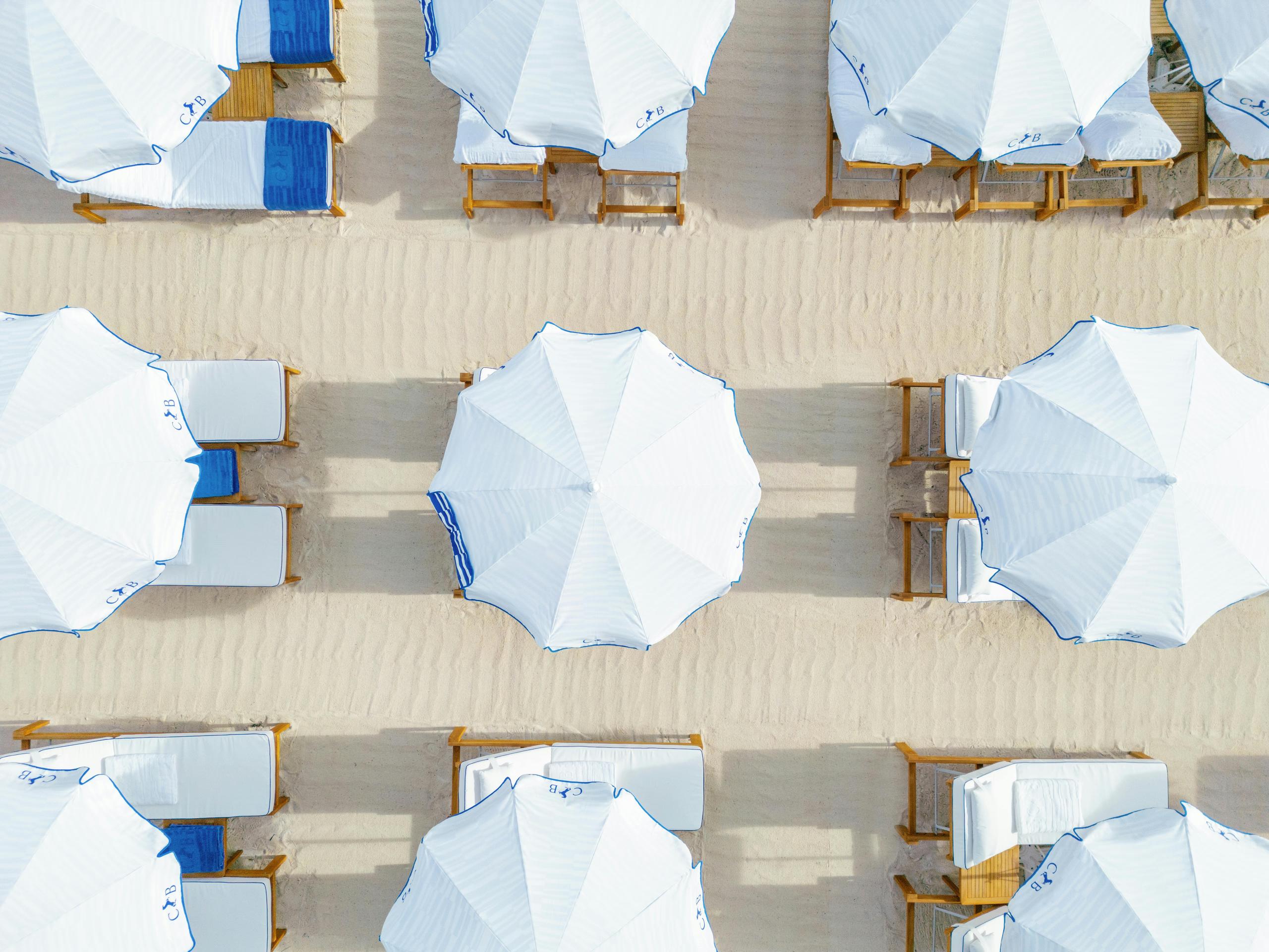 Cheval Blanc St-Tropez: aerial view of striped umbrellas and sunbeds in organized rows