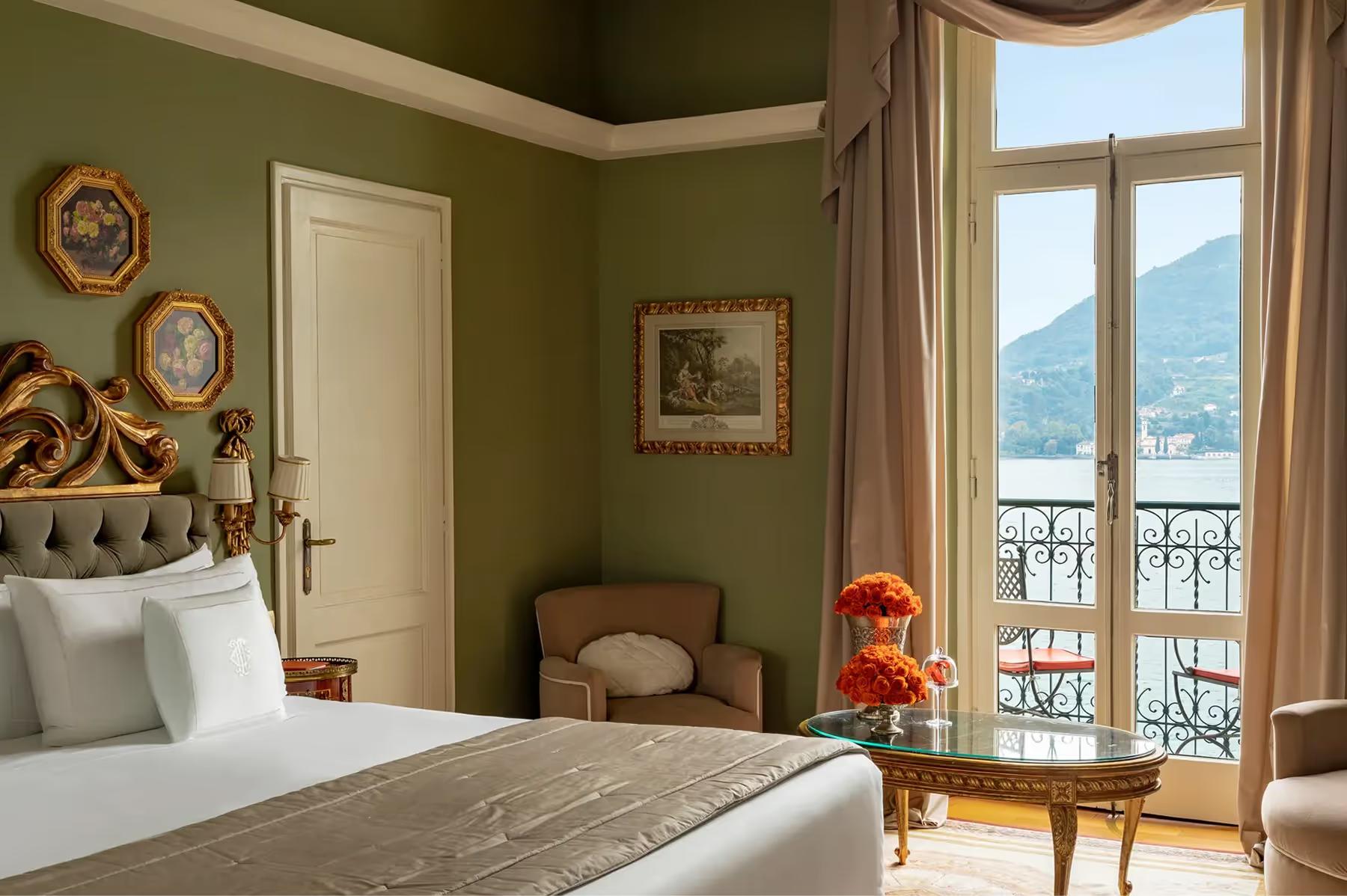 Grand Hotel Tremezzo: bedroom with sage walls, white linens, and balcony doors to mountain lake views