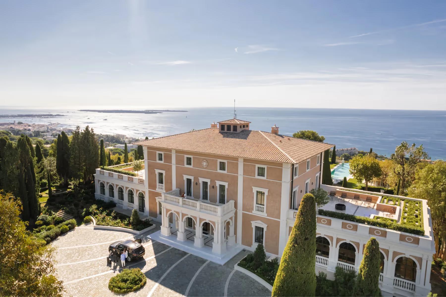 Le Château de La Croix des Gardes: cream-colored château with sea views, pool complex, and surrounding estate grounds