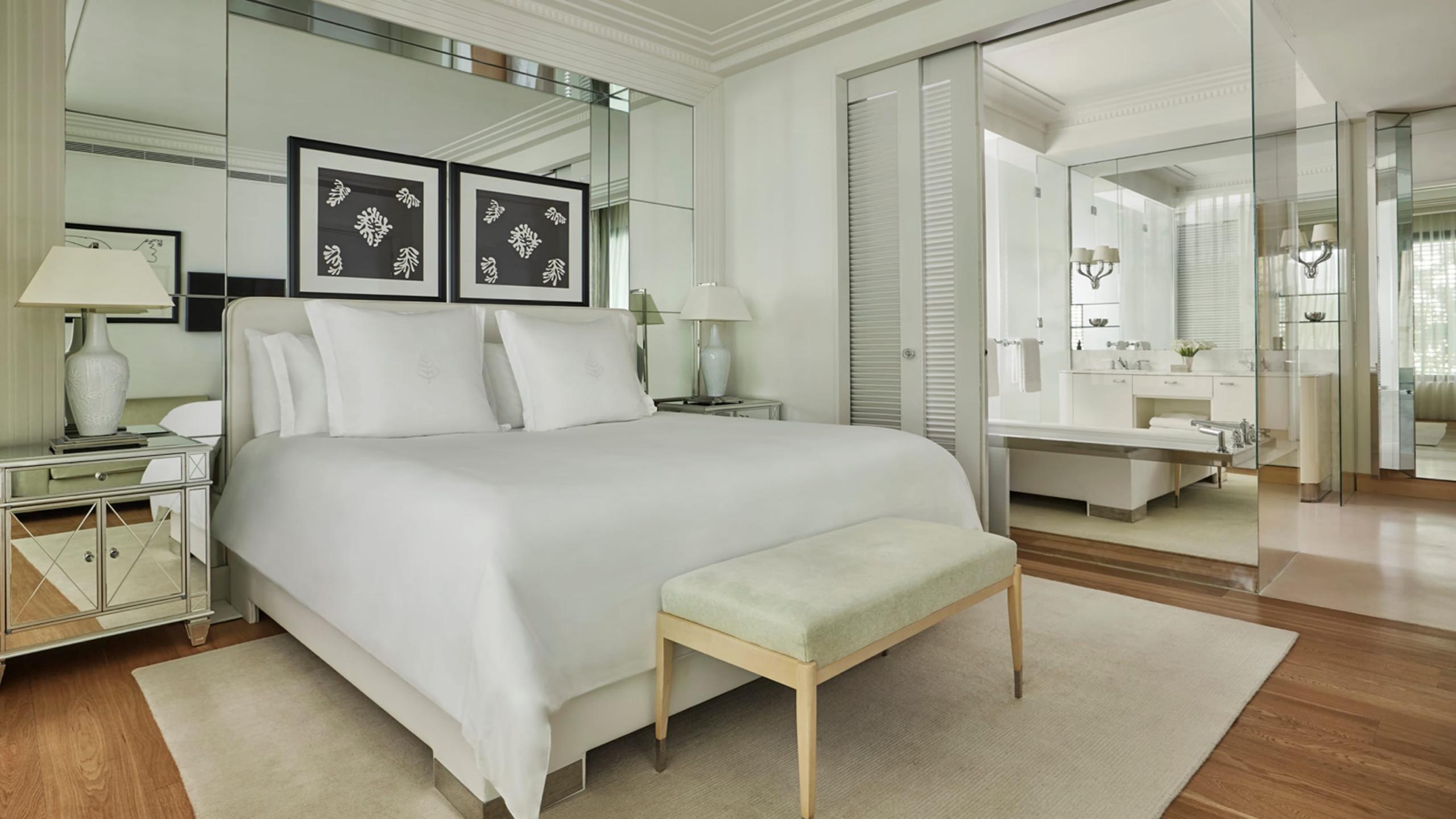Grand-Hôtel du Cap-Ferrat: contemporary bedroom with mirror-lined closet and pale wood furnishings