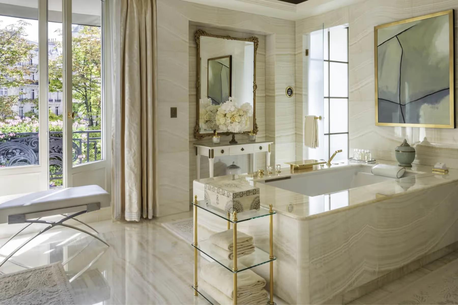 Four Seasons Hotel George V: a detail shot of a marble bathroom vanity with a white flower arrangement