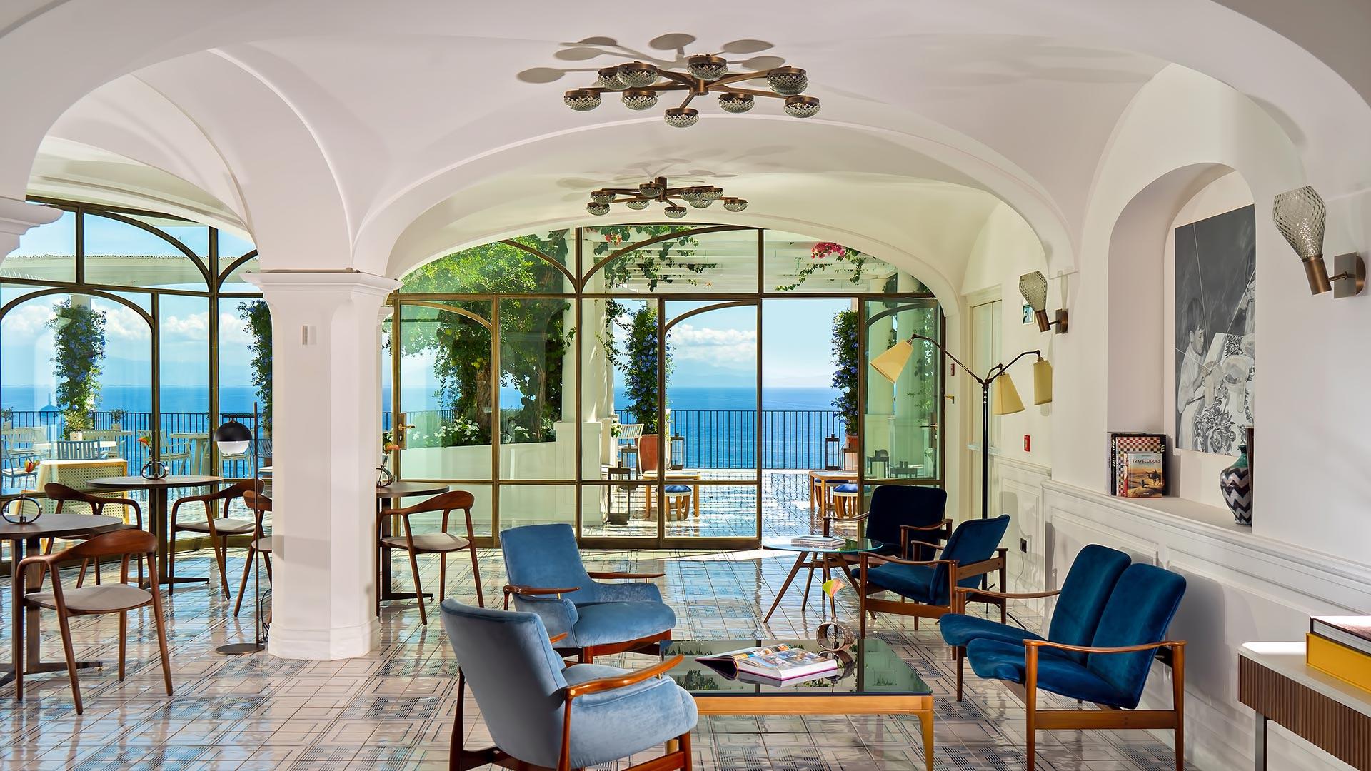 Light-filled lounge with columns, arched ceilings, and views to the seascape