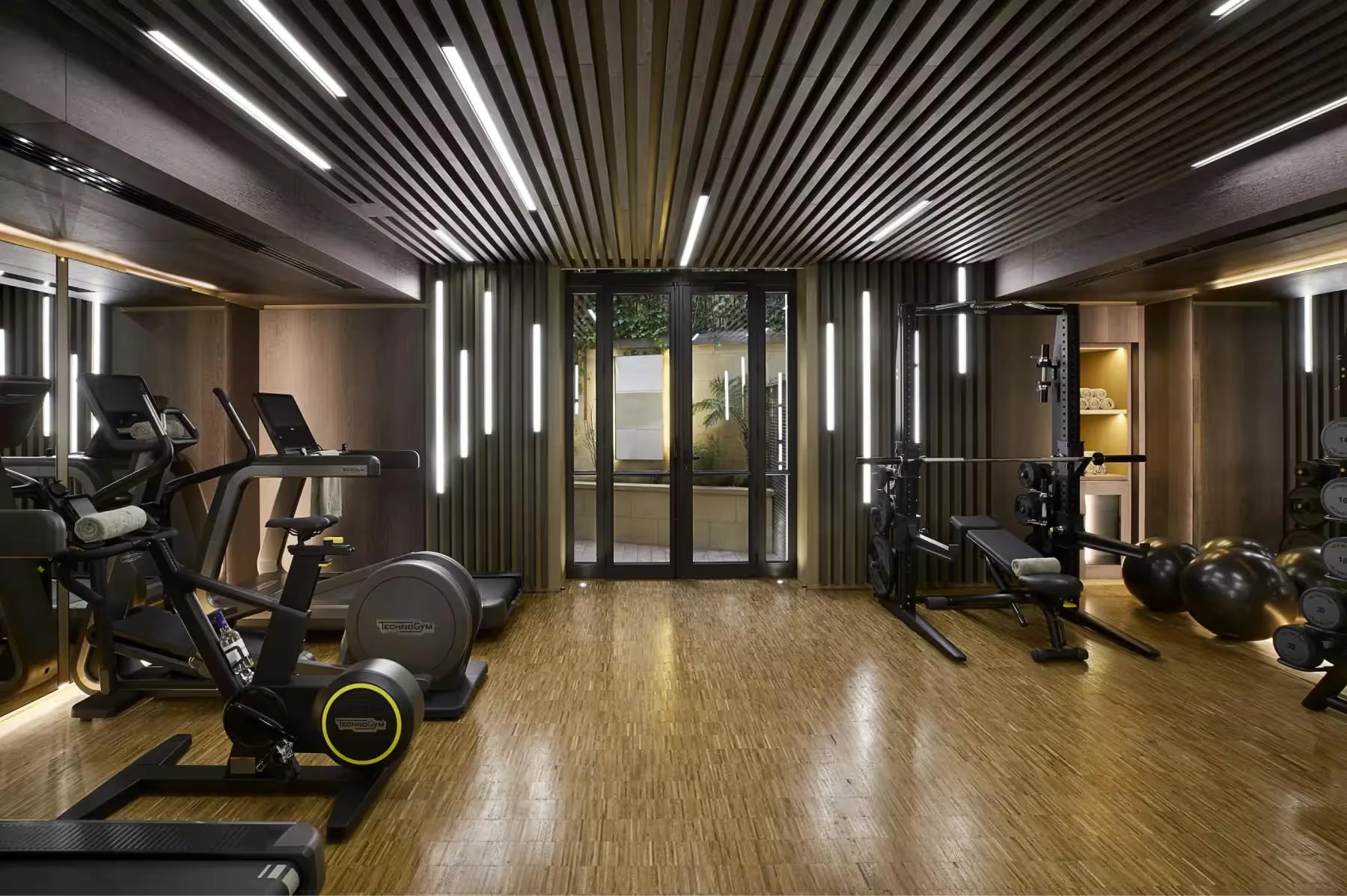 Maison Villeroy: a spa entrance with black metal cylindrical sculpture and arched entryway