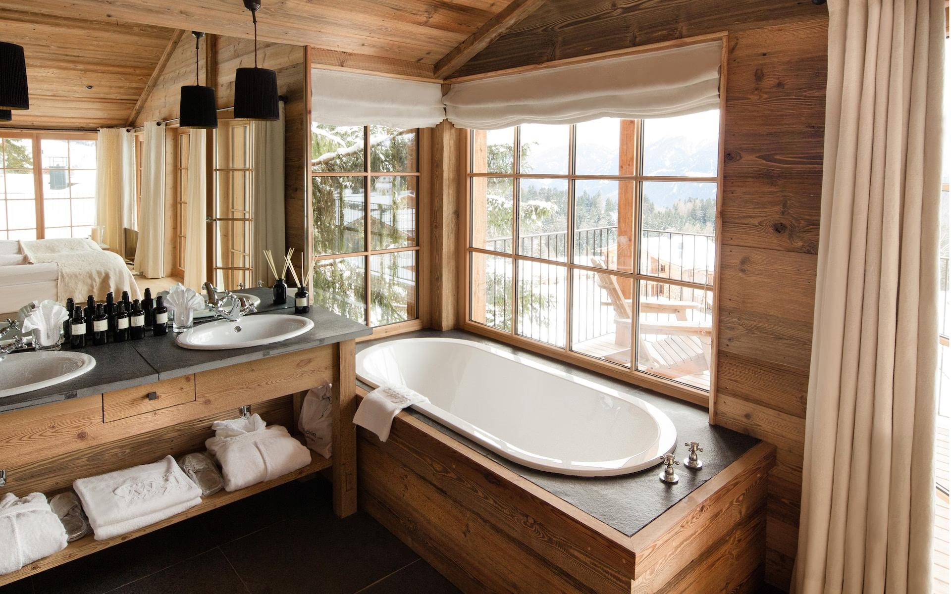 San Luis Retreat: wooden bathroom with a large soaking tub beside a sink vanity near windows