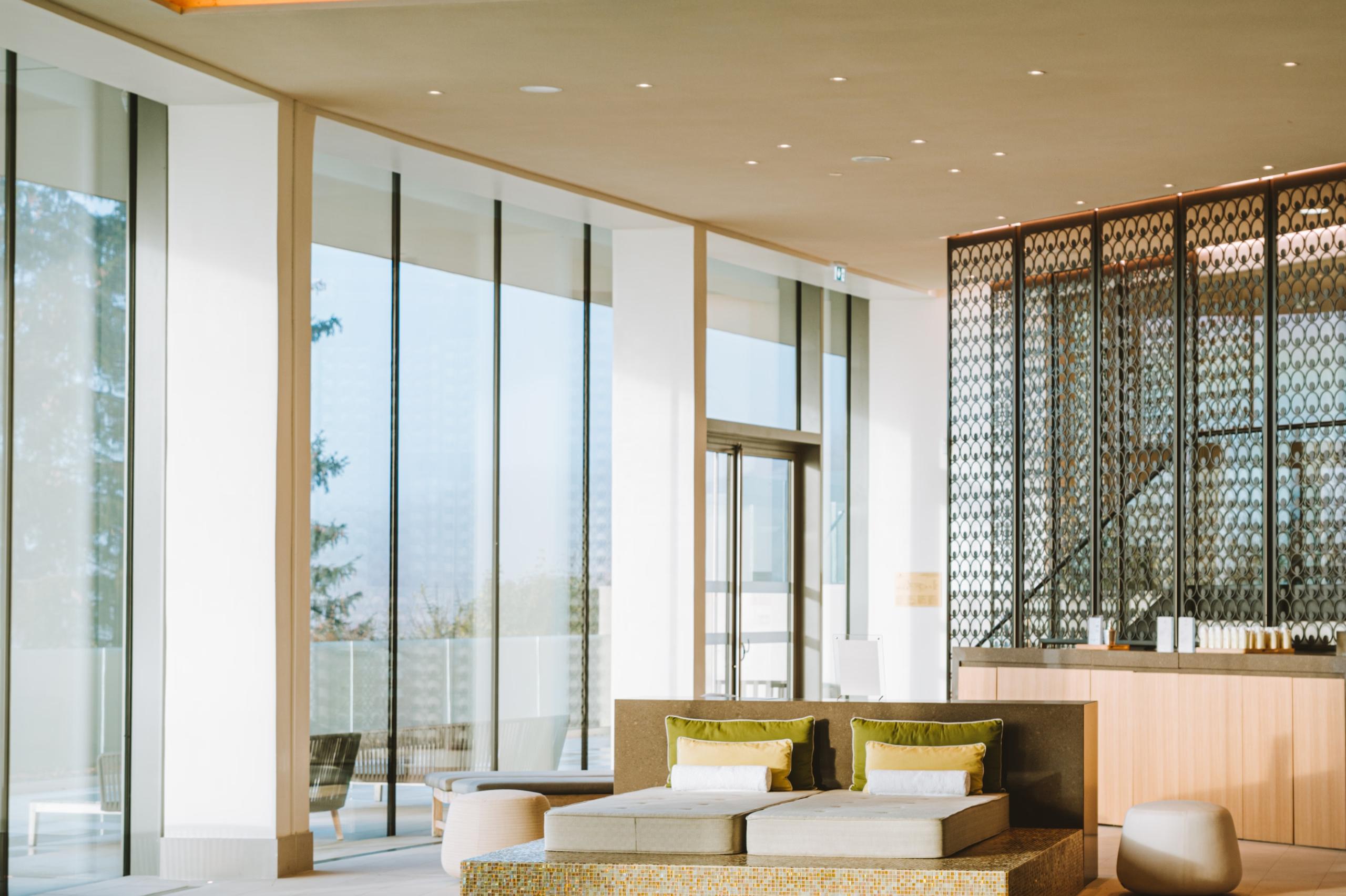 Wellness suite with seating area and large windows with mountain valley views