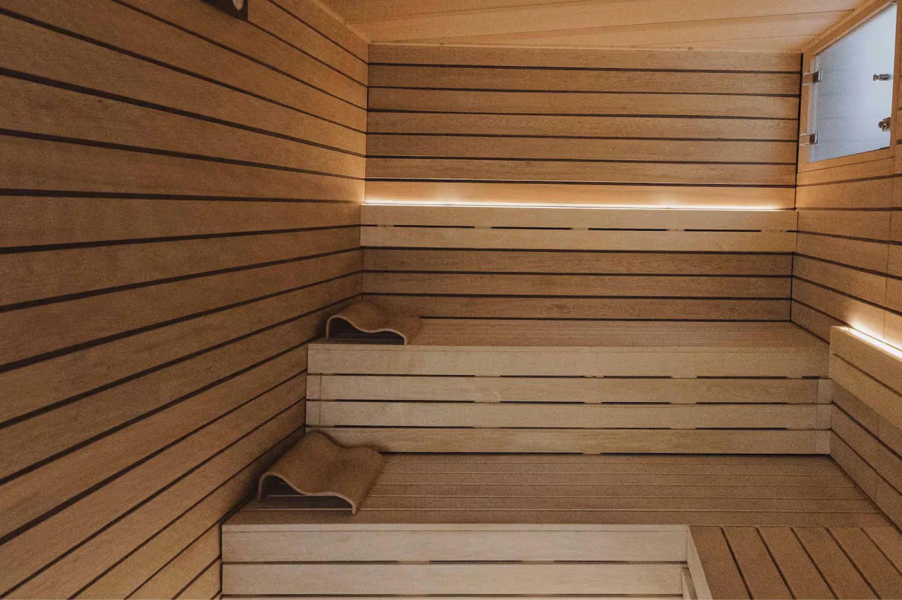 Maison Villeroy: a fitness center with dark wood floors, equipment, and glass doors