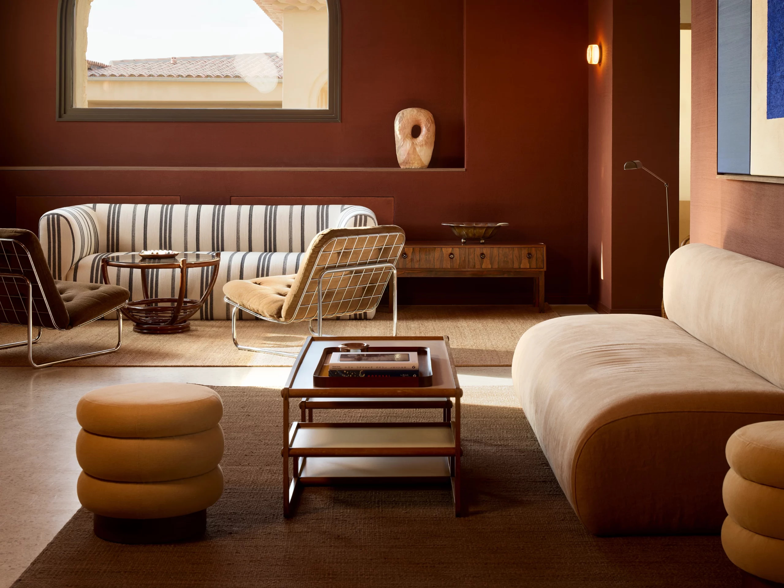 Zannier Île de Bendor: a terracotta lounge pairs a striped sofa with wire frame chairs and a marble topped table