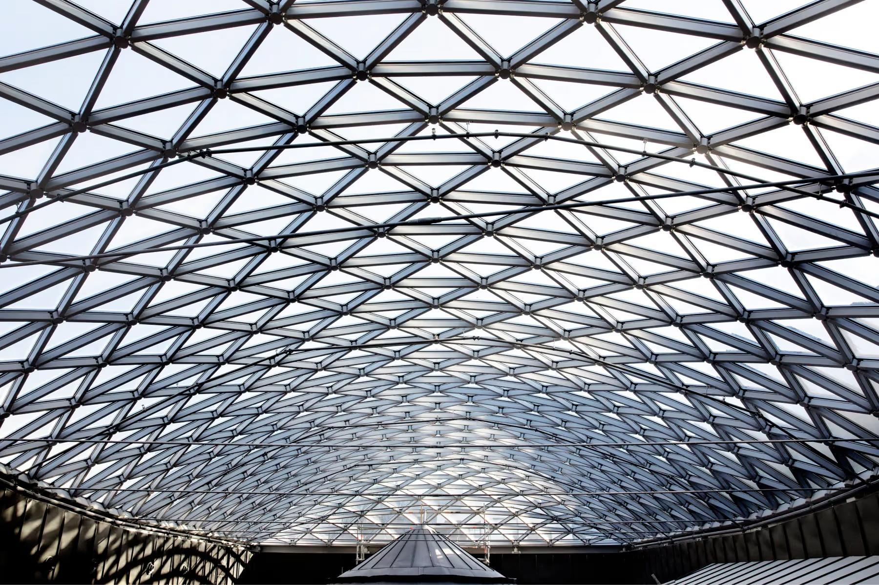 Geometric glass and steel roof structure with symmetrical lattice pattern