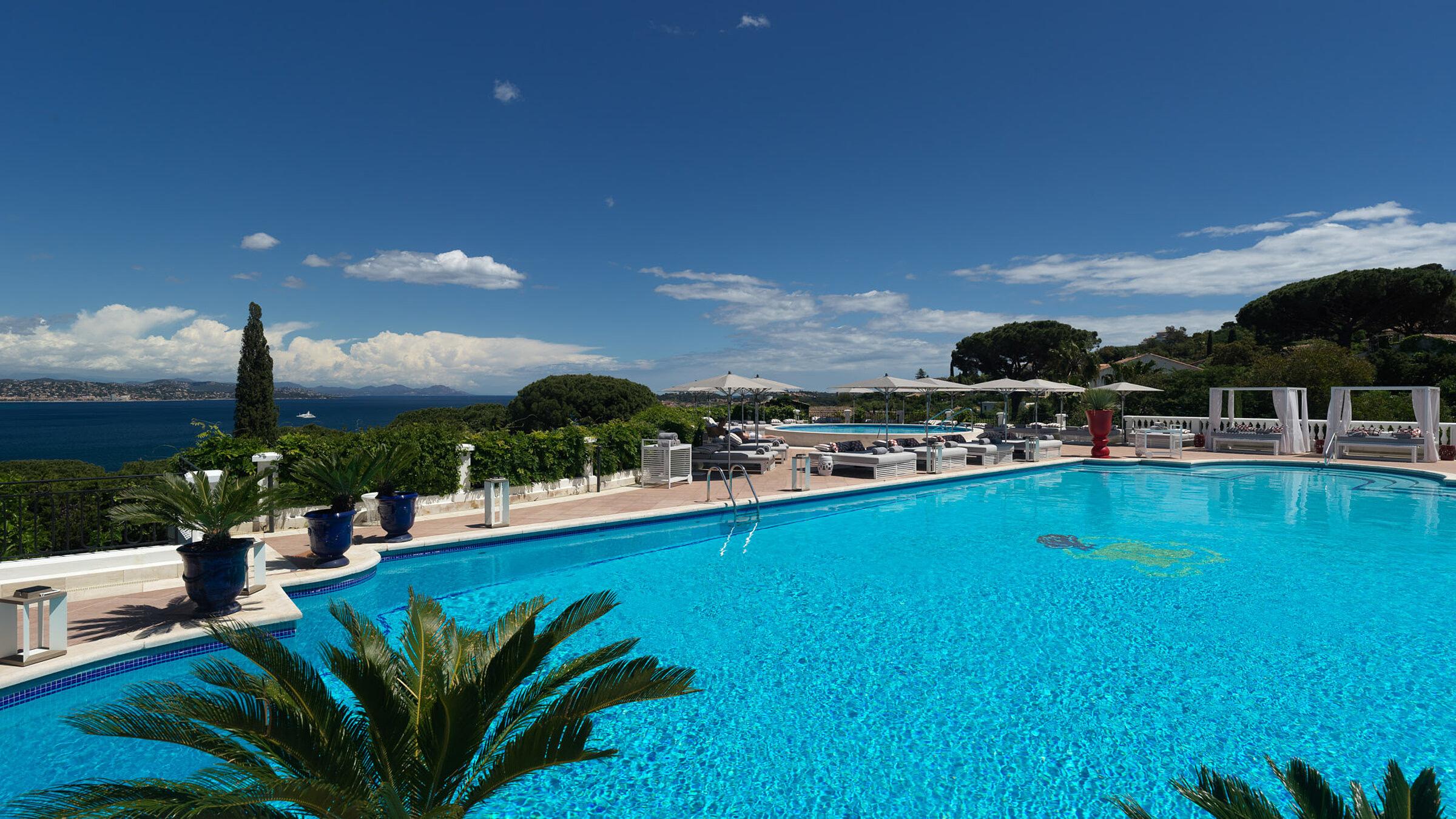 Blue lap pool and surrounding terraces with Mediterranean views