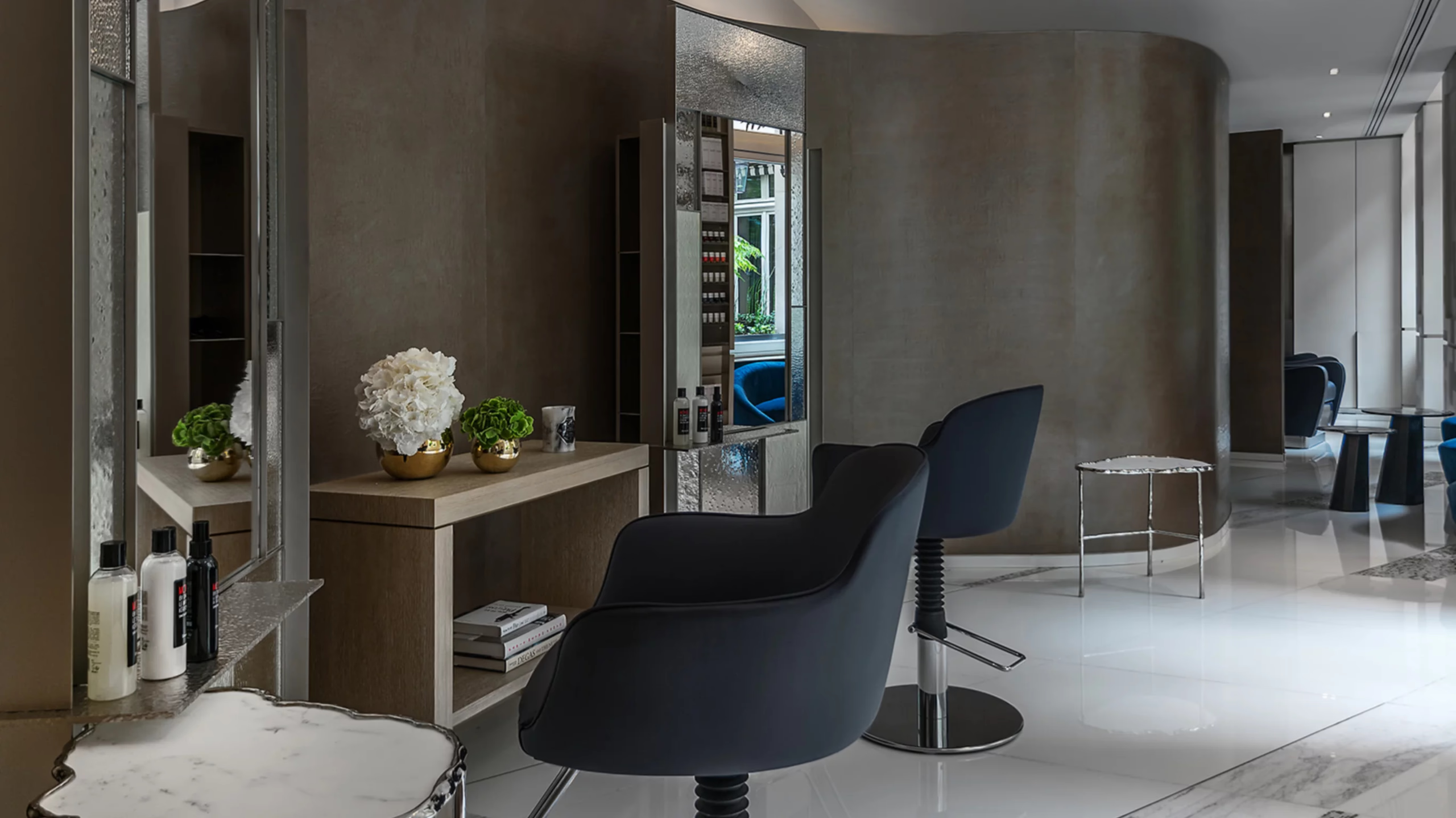Spa vanity with round mirror and personal care amenities displayed