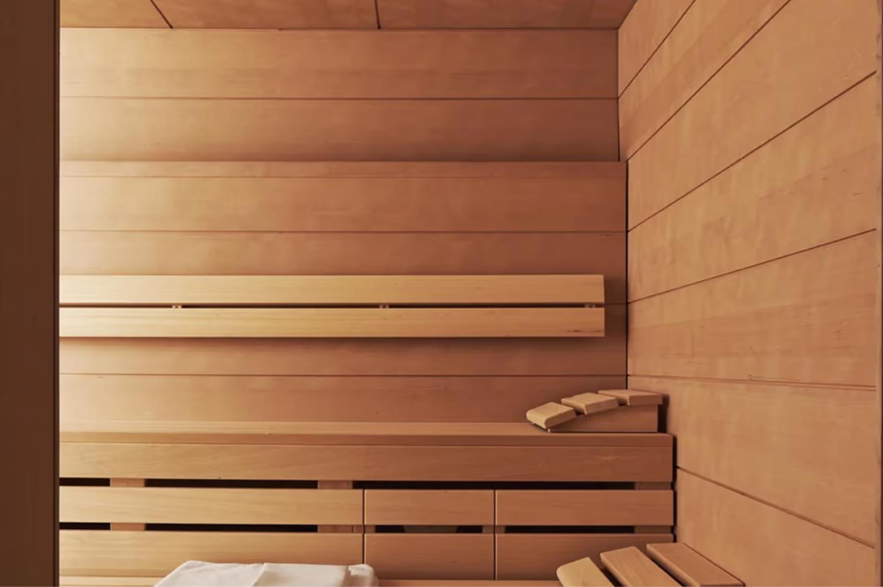 A sauna interior with light wood construction and parallel benches