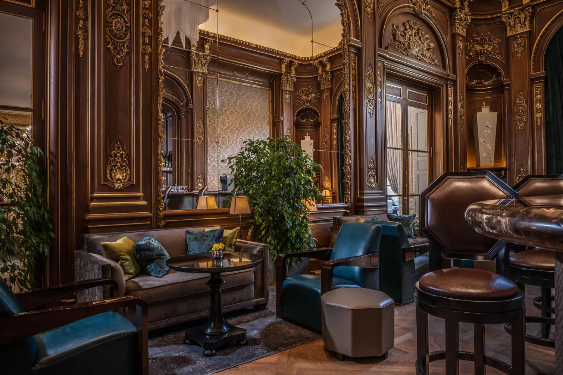 The Peninsula: bar with mirrors reflecting bottles, classical architectural details, and seated guests
