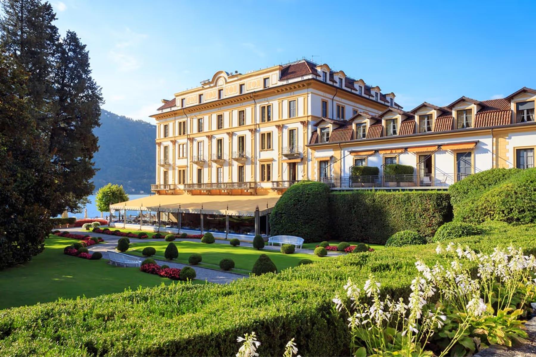 Villa d’Este: pale yellow Renaissance palazzo with sloped roof overlooking manicured gardens and lake