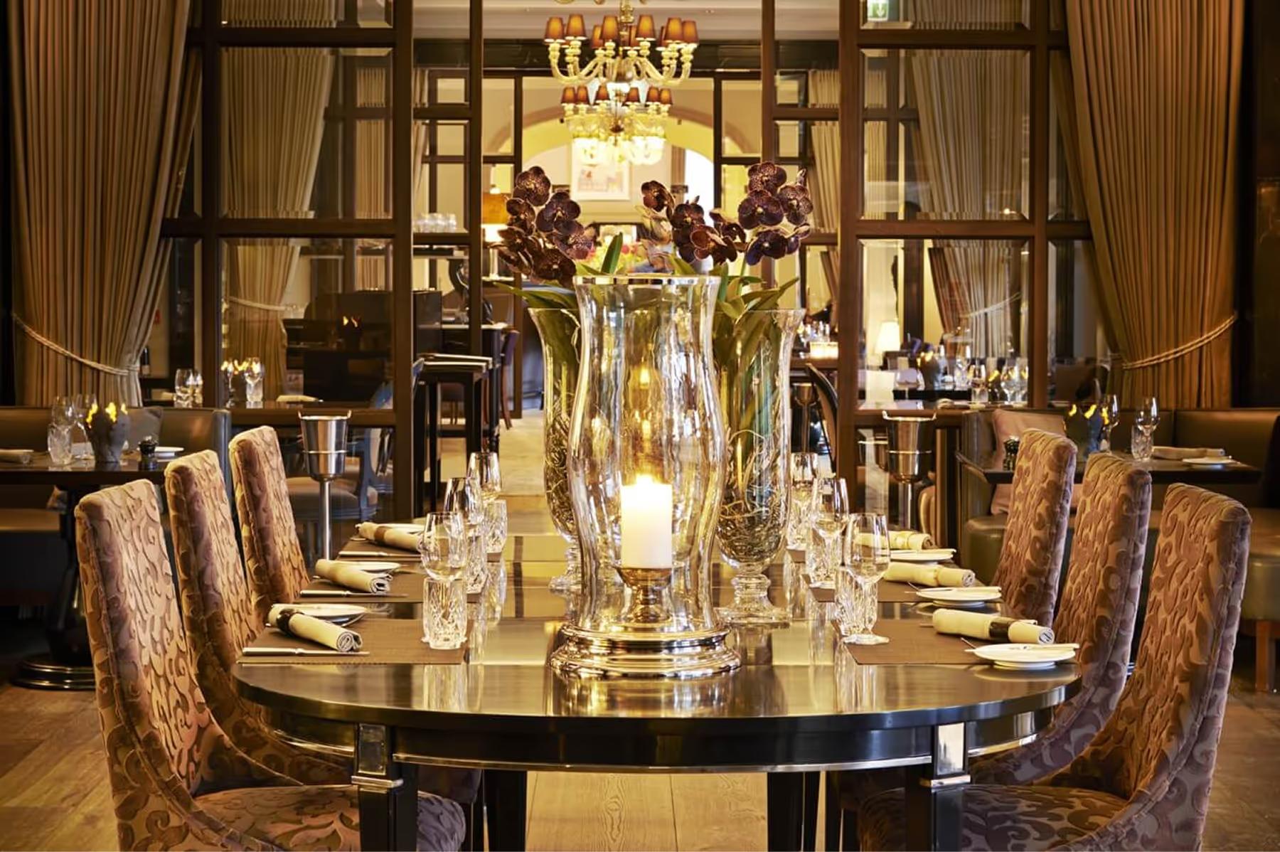 Hotel d’Angleterre: private dining table set for two with crystal stemware and chandelier