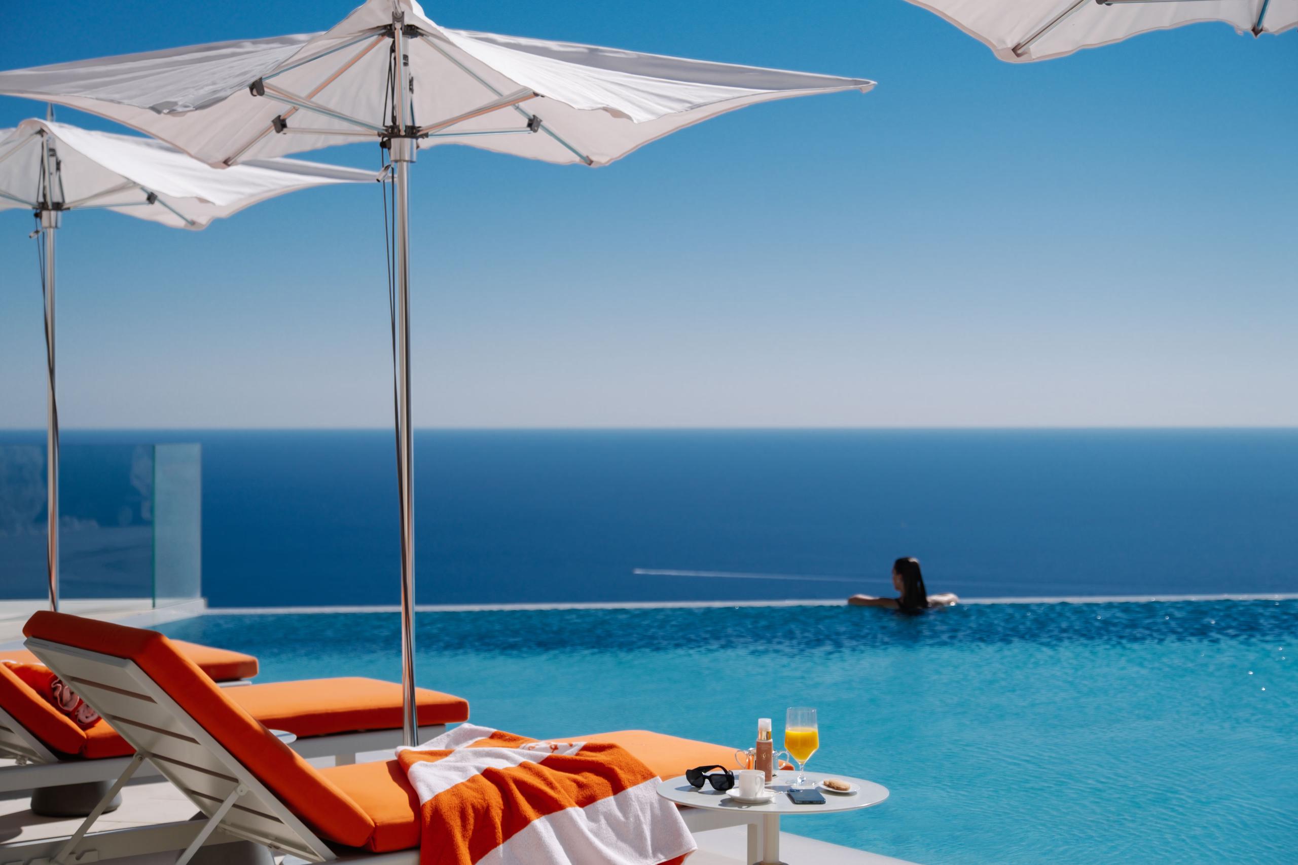 Maybourne Riviera: pool lounge with white umbrella and turquoise water