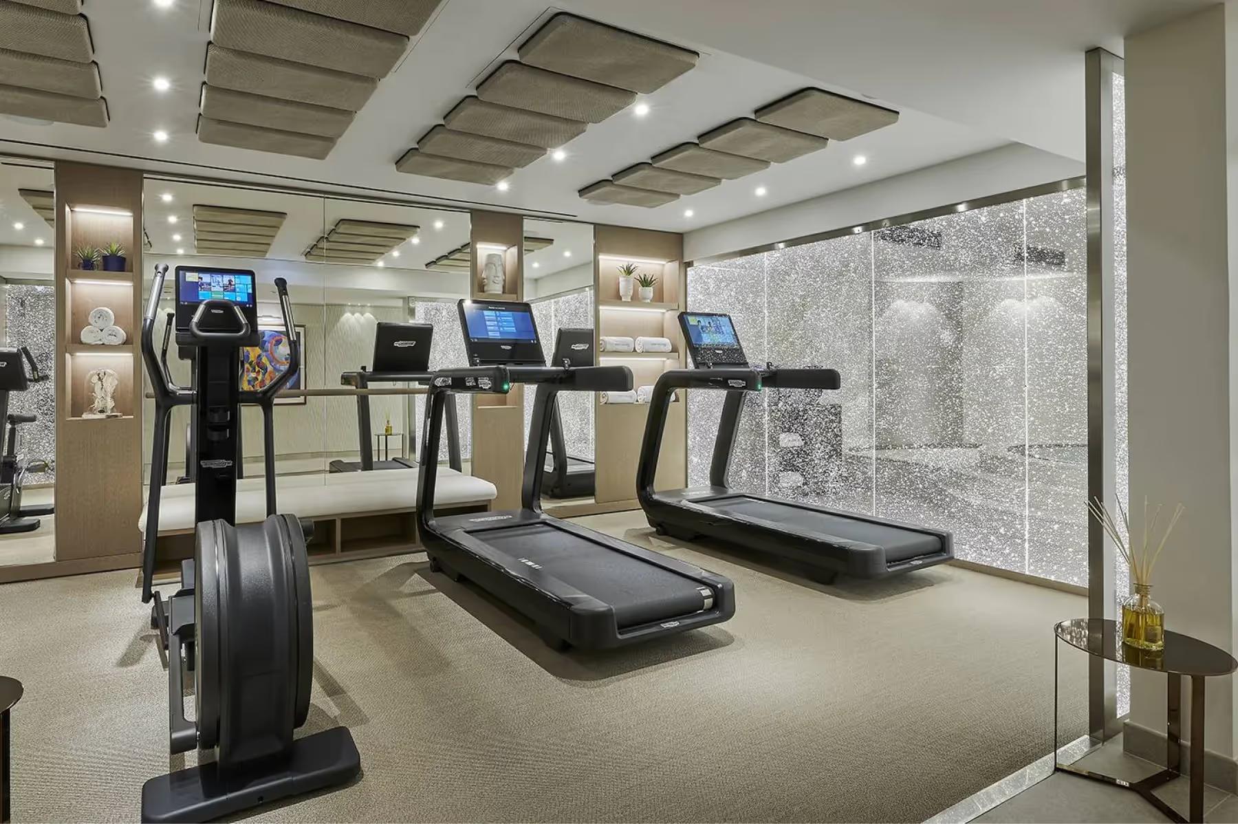 Fitness center with cardio equipment and bright interior