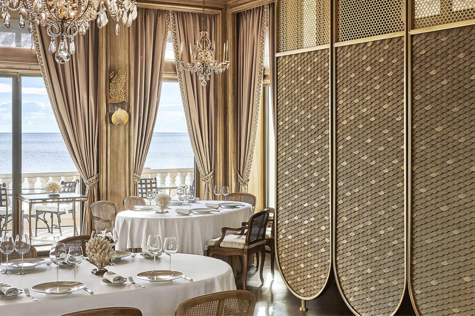 Intimate dining alcove with individual tables and Mediterranean views