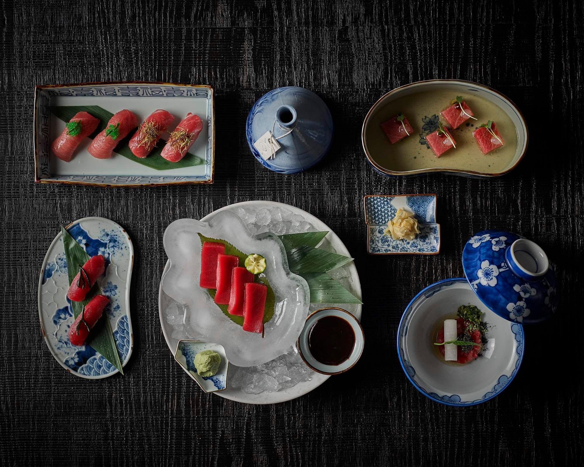 Mandarin Oriental Conservatorium, Amsterdam: sushi and sashimi on blue-and-white dishes, seen from above on a dark wooden table