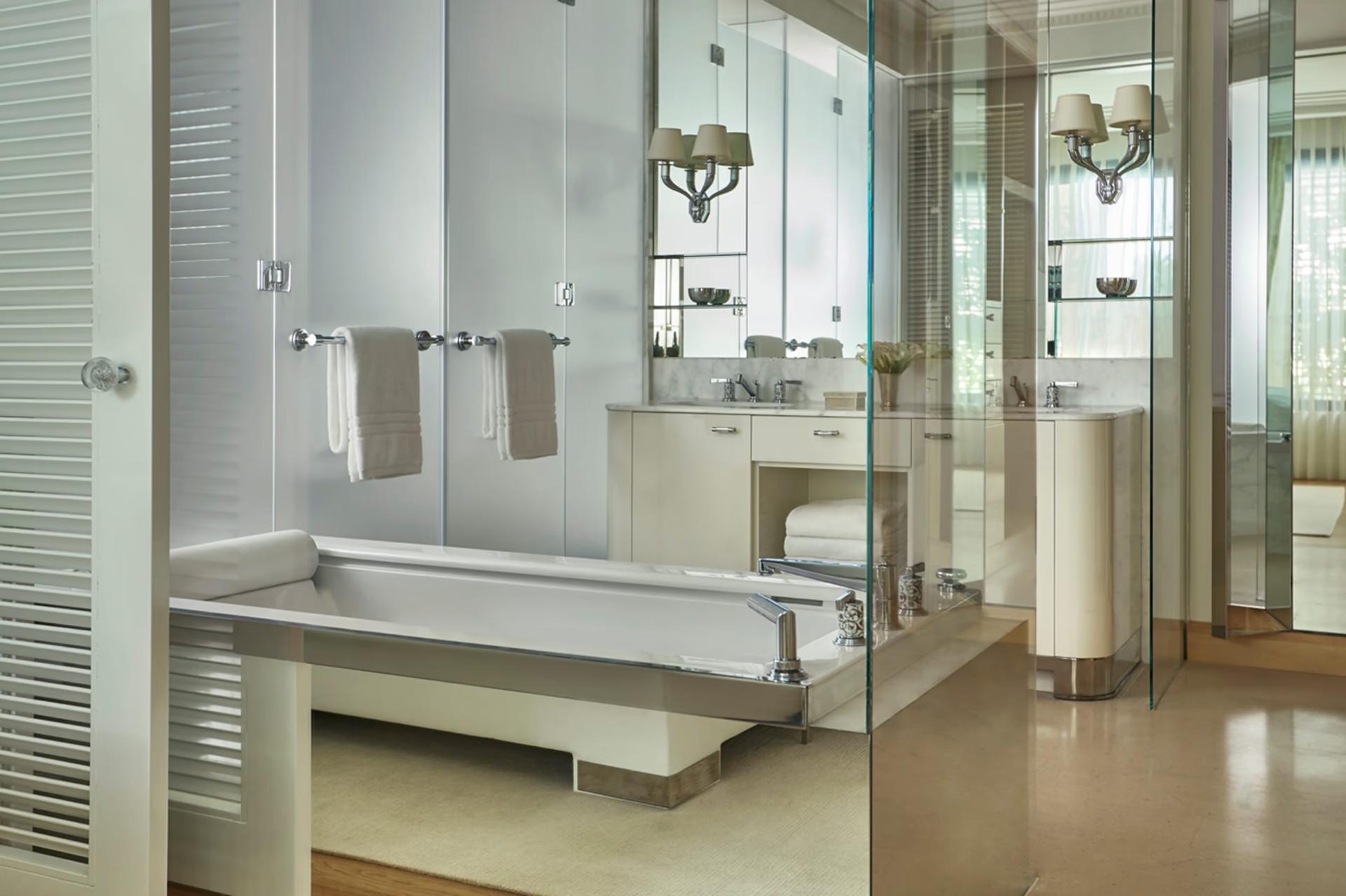 Modern marble bathroom suite with dual vanity and walk-in shower