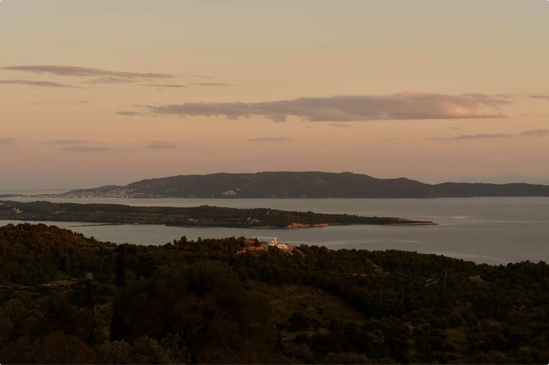 Dusk landscape showing bay waters and forested shoreline