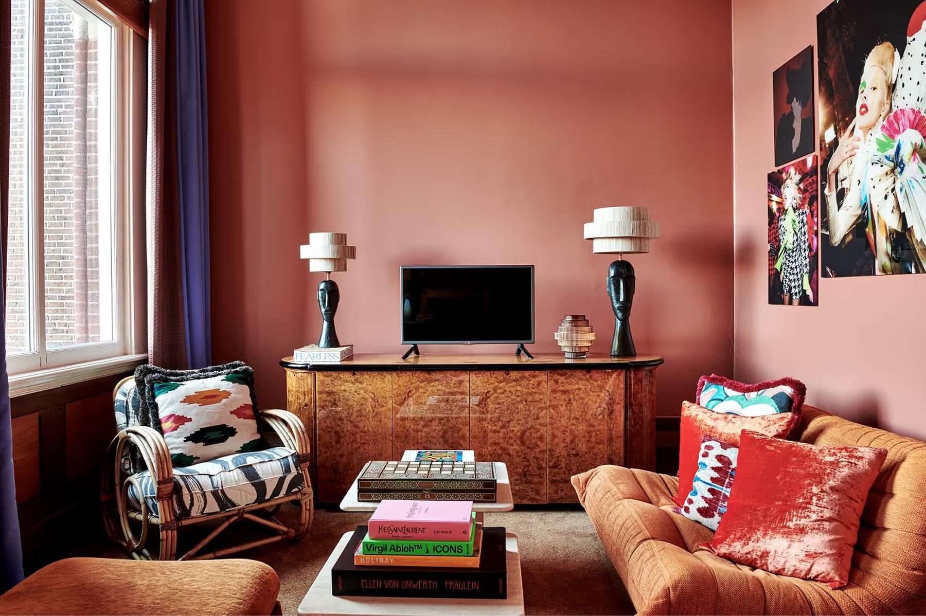 Corner suite with warm brown walls, patterned upholstery, and compact seating arrangement