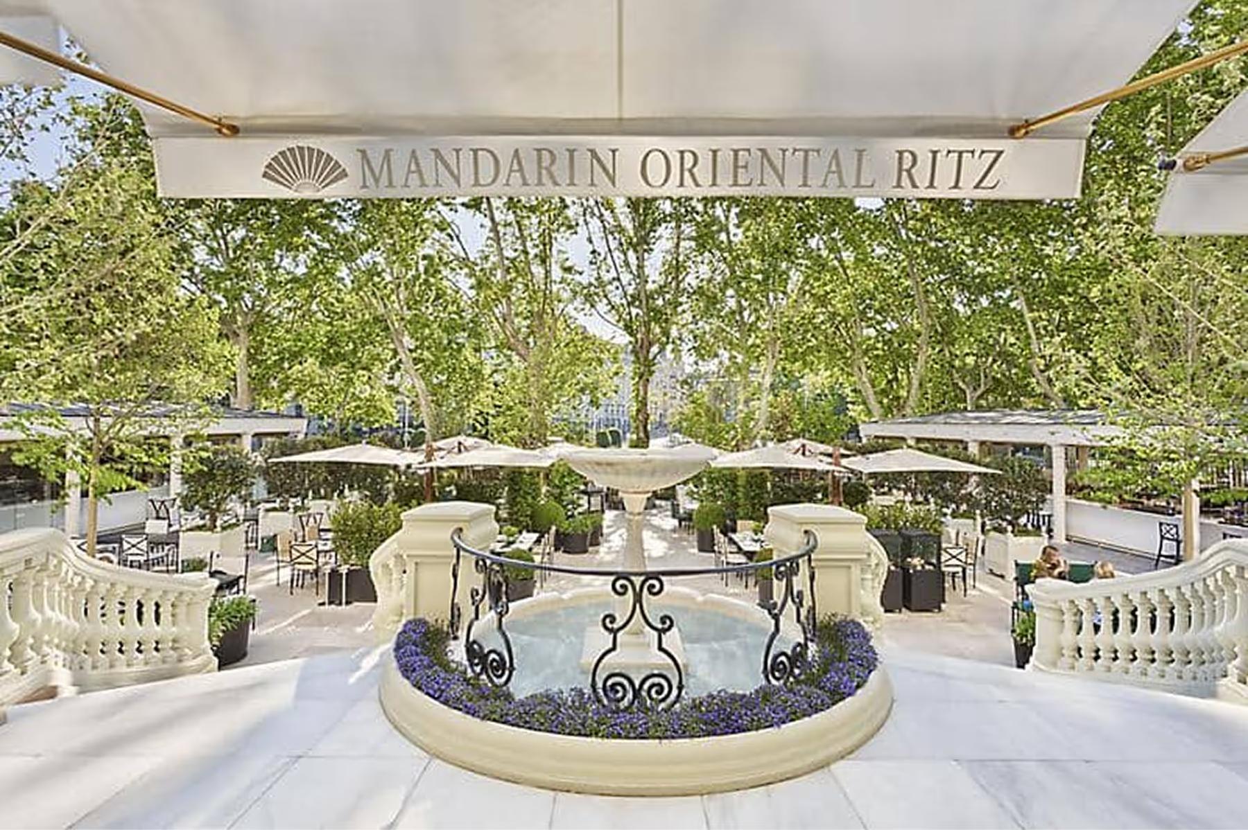 Terraced courtyard with cream furniture and circular fountain