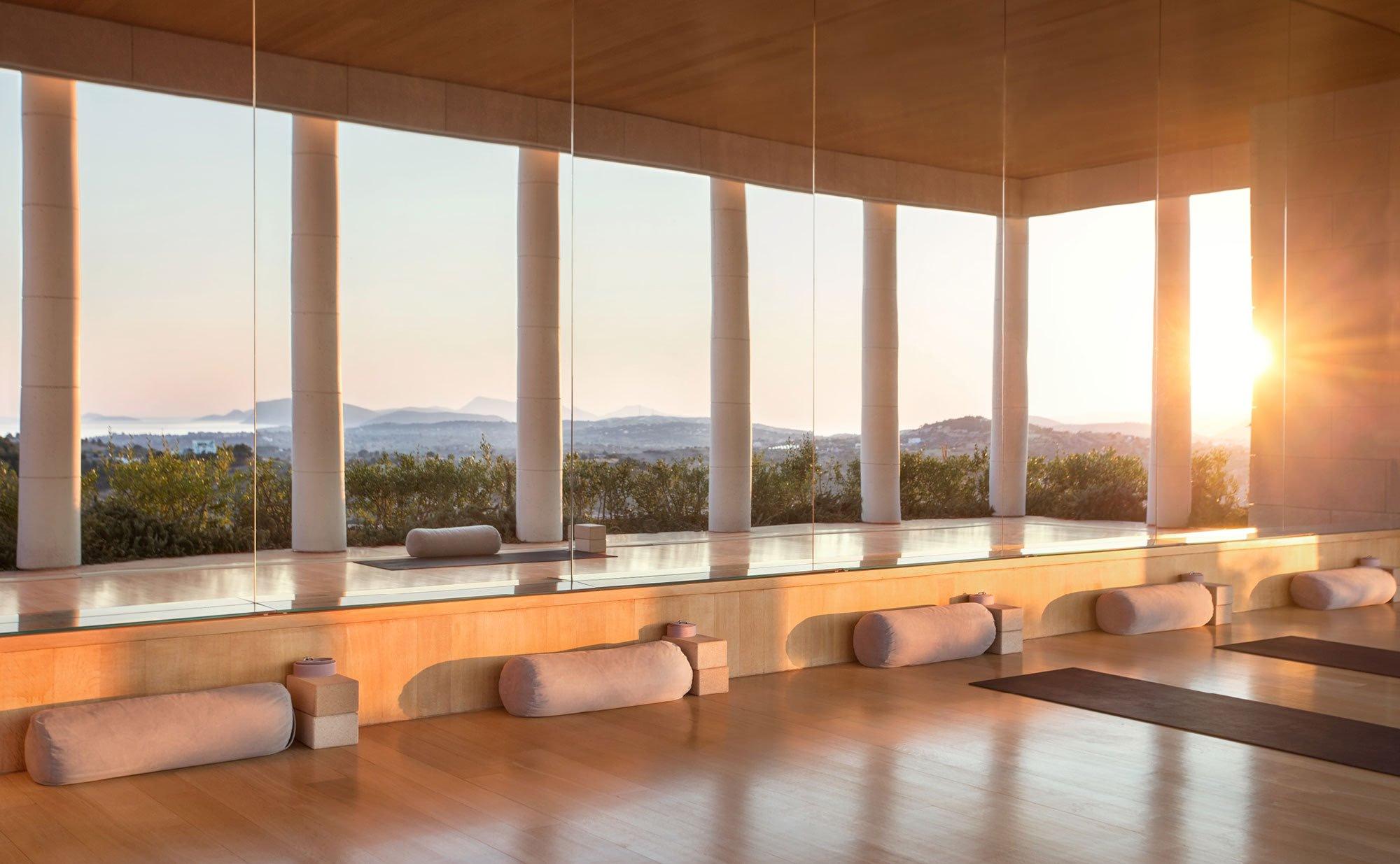 Spa yoga studio with columns and sea view at sunrise