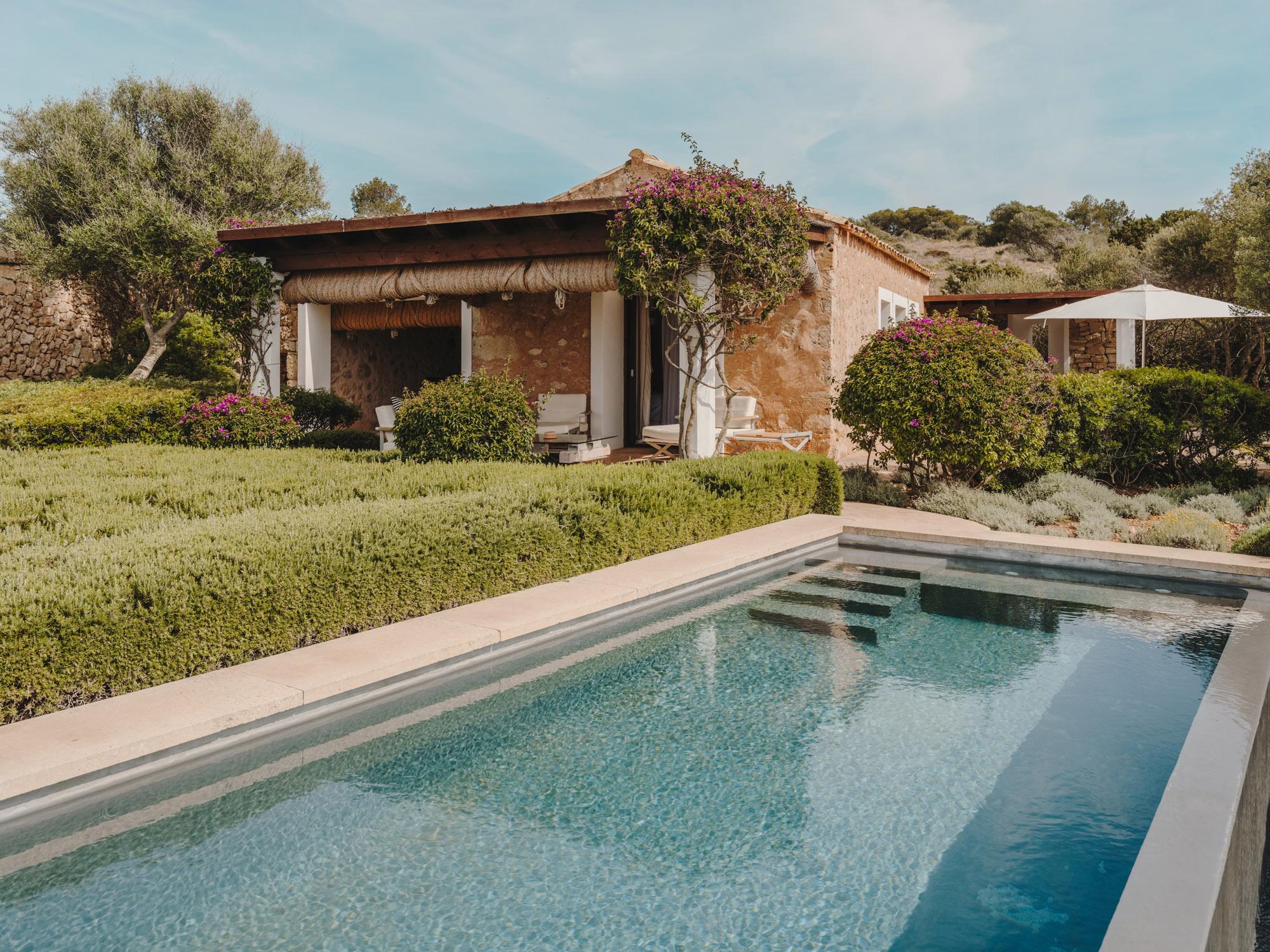 Cap Rocat: cushioned loungers and a cream parasol on a stone terrace overlooking the sea